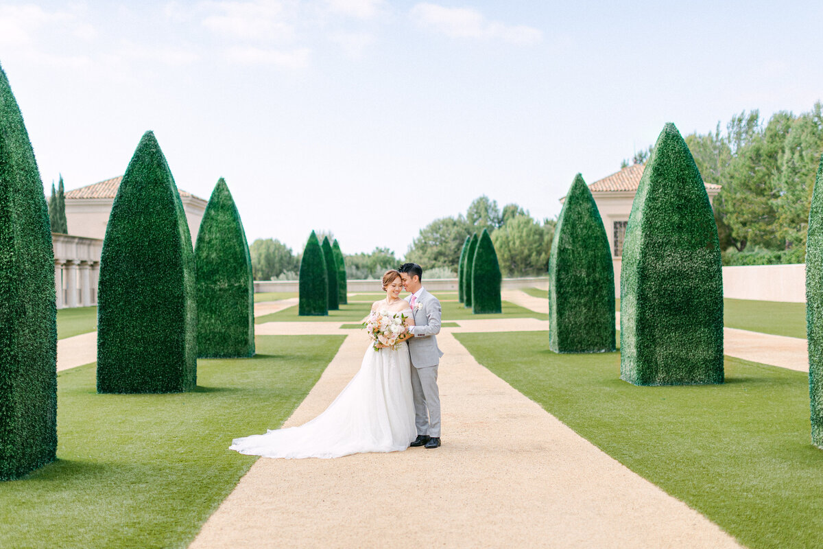 A quiet moment on the gravel allee between towering topiary