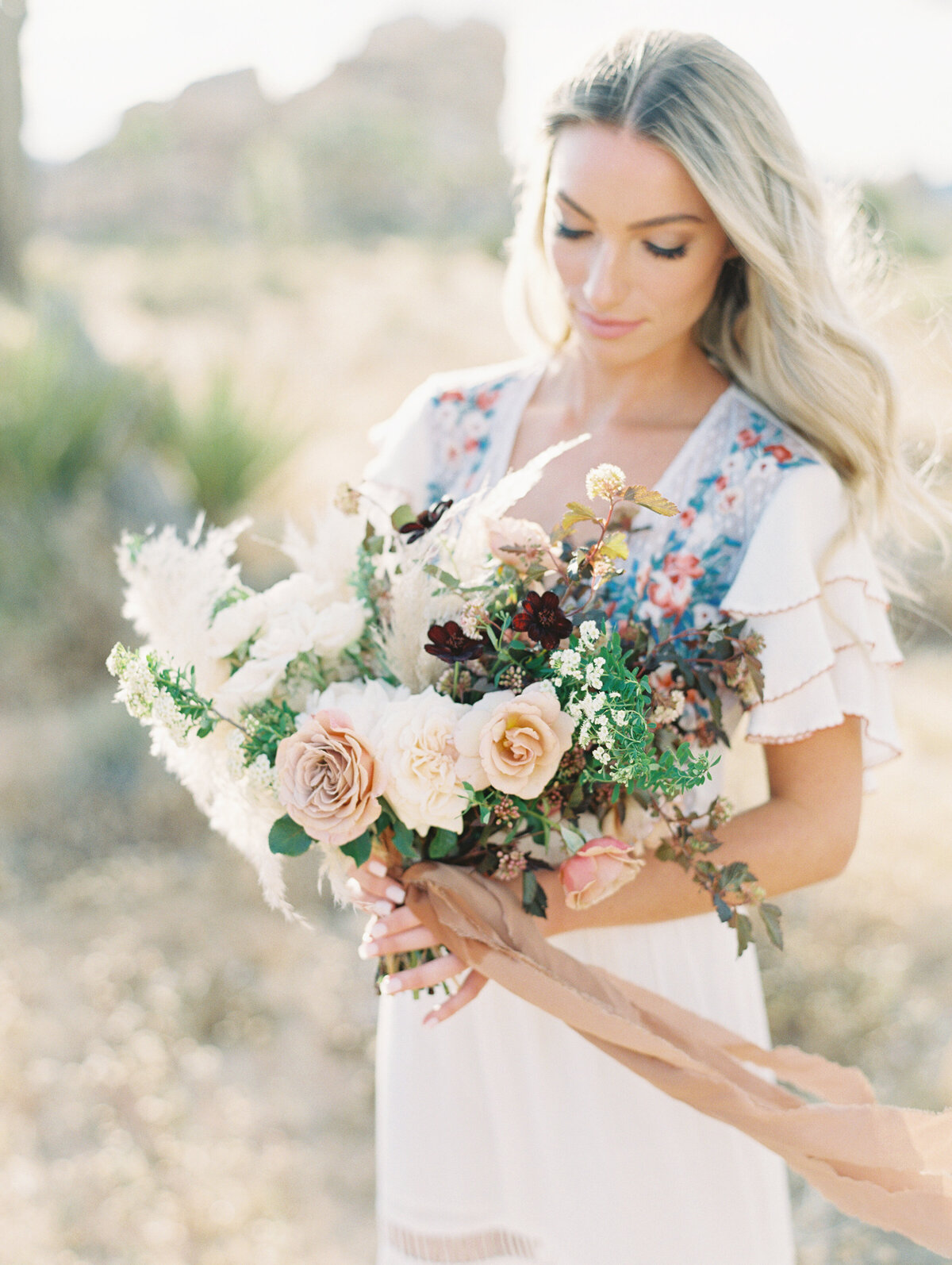 Pampas and toffee roses, silk ribbon loose in the desert wind