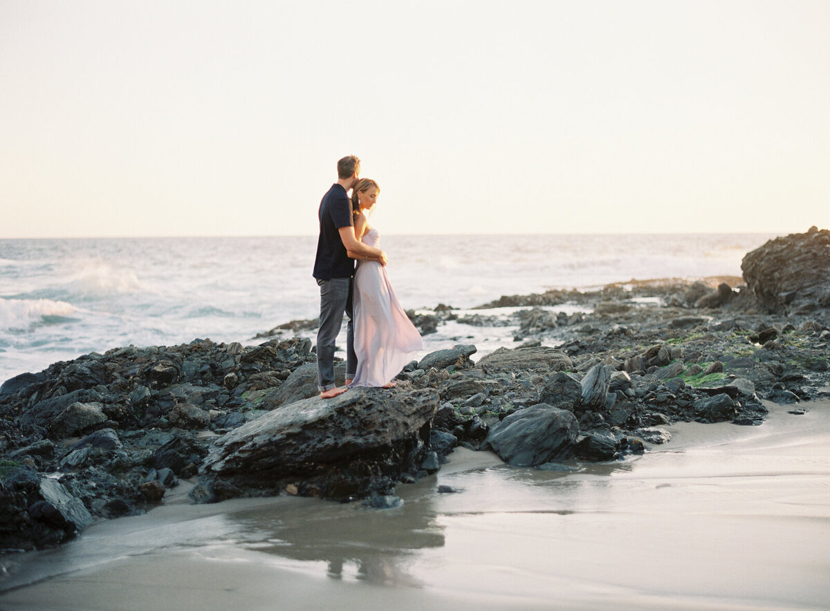 Wrapped together on the tide rocks as the surf rolls in