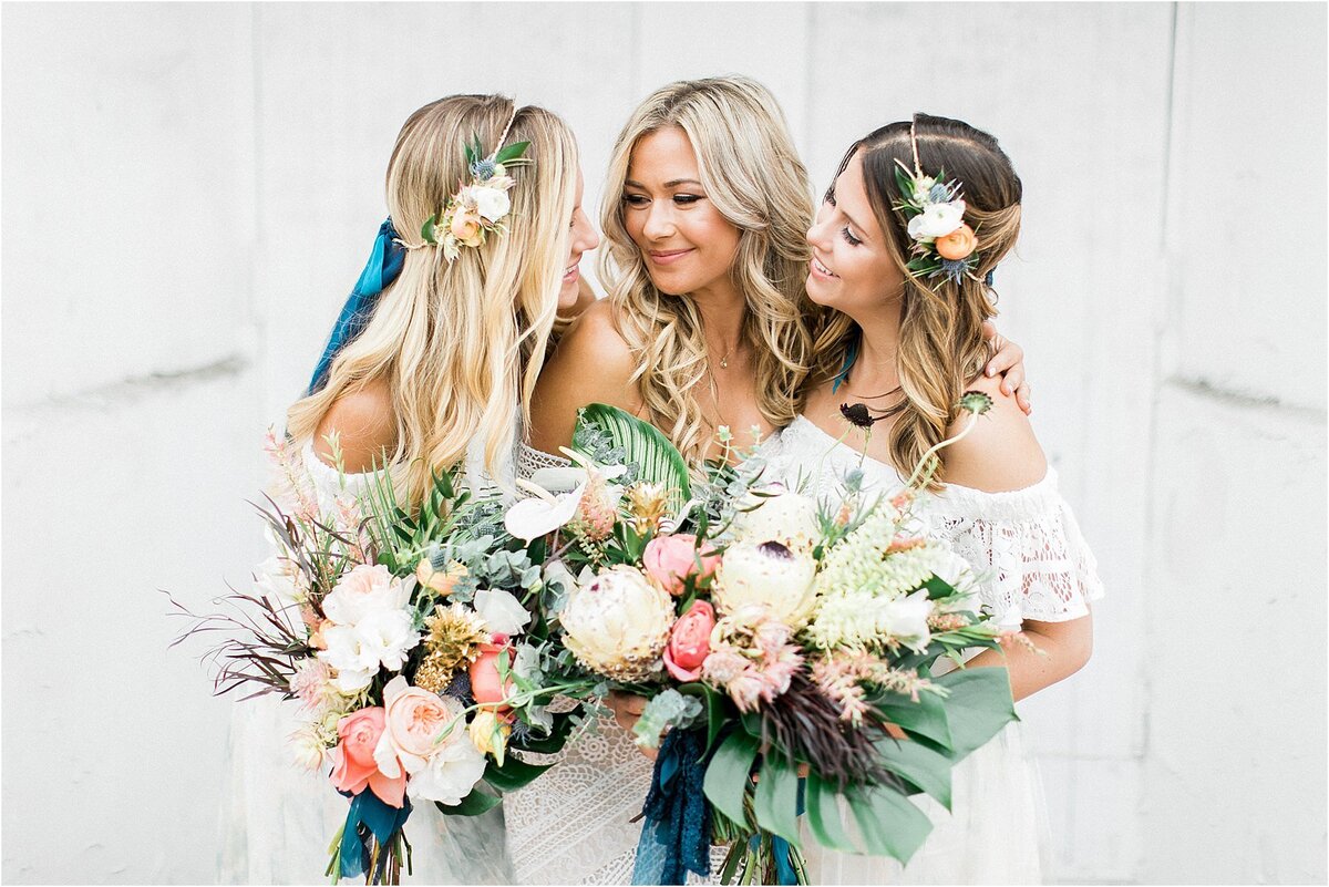 Three of them in lace, anthurium and protea in the bouquets