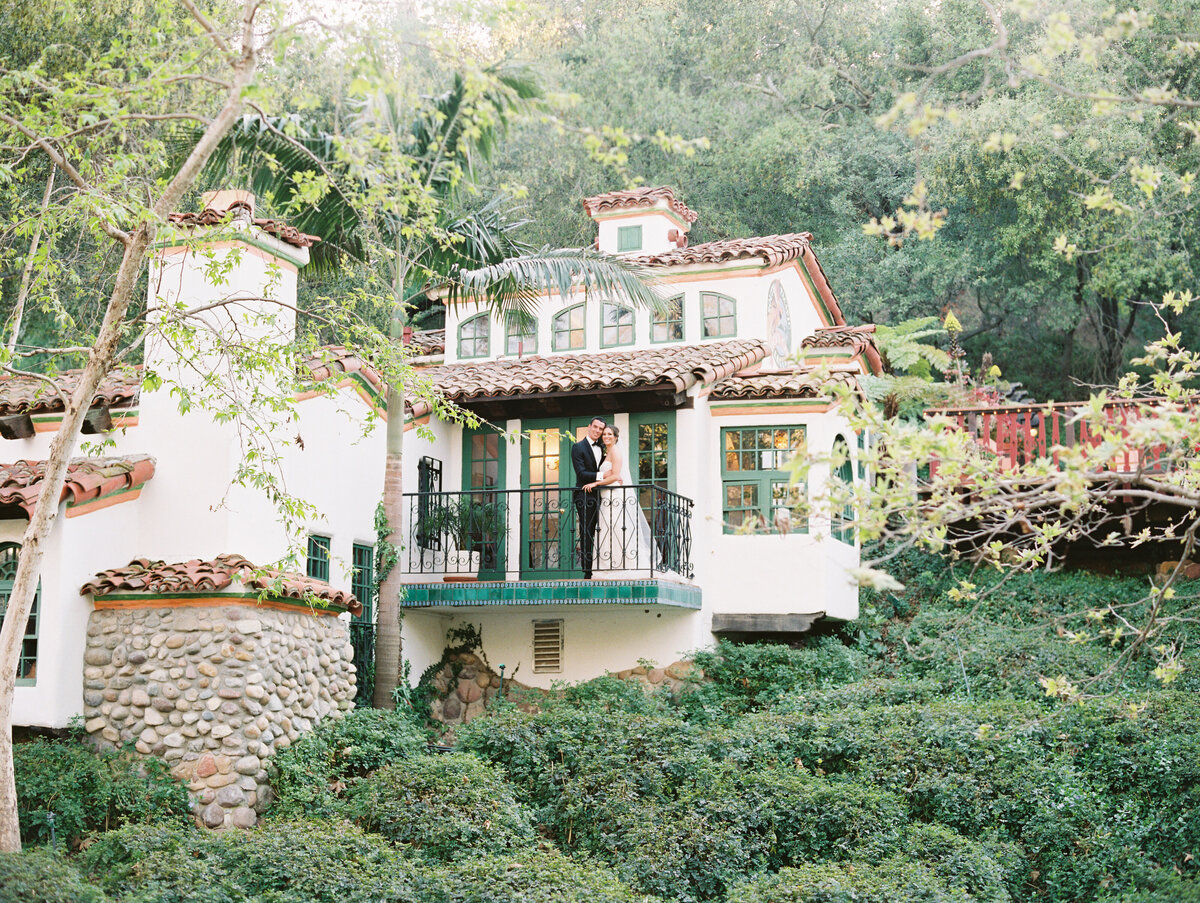 On the balcony of the storybook casita, gardens closing in around it