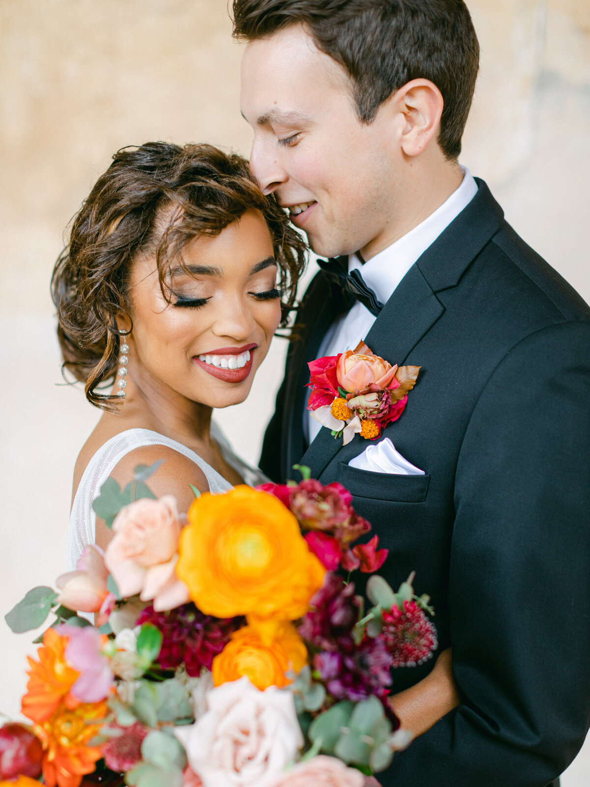 A kiss at her temple, ranunculus burning orange in the bouquet
