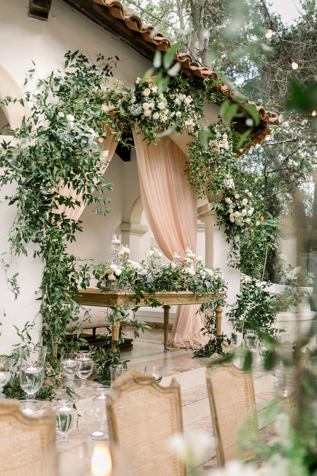 Greenery and blooms hung above the tables