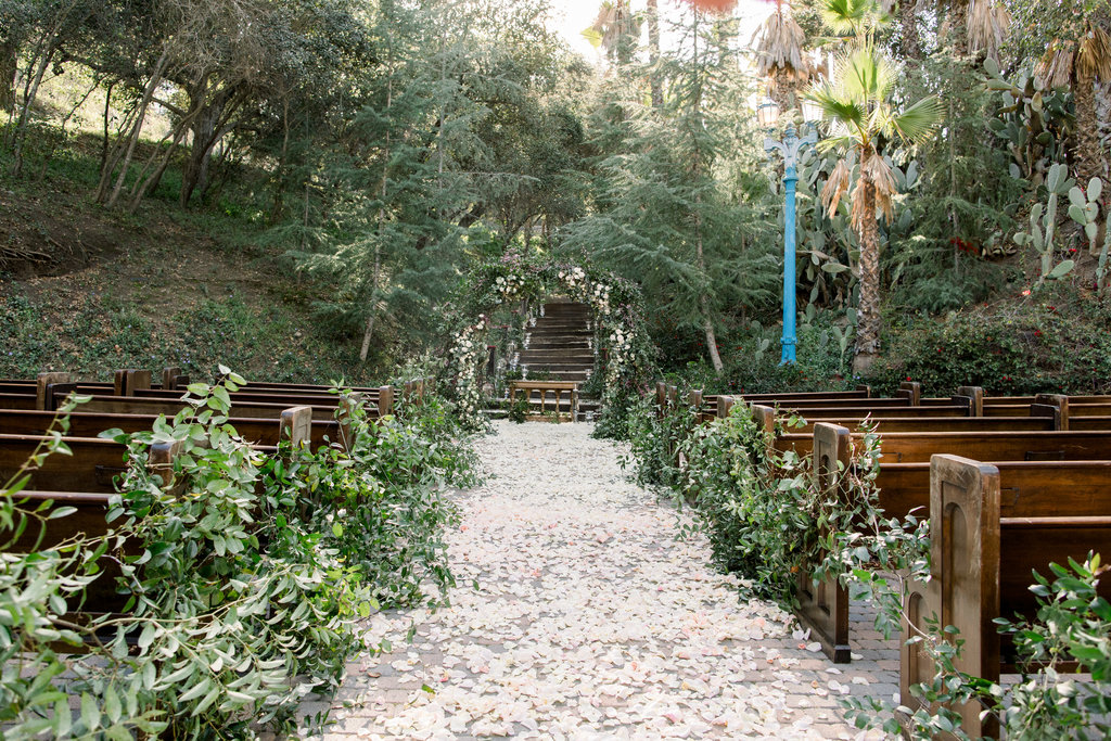 Petals and benches beneath the oak canopy at Rancho Las Lomas