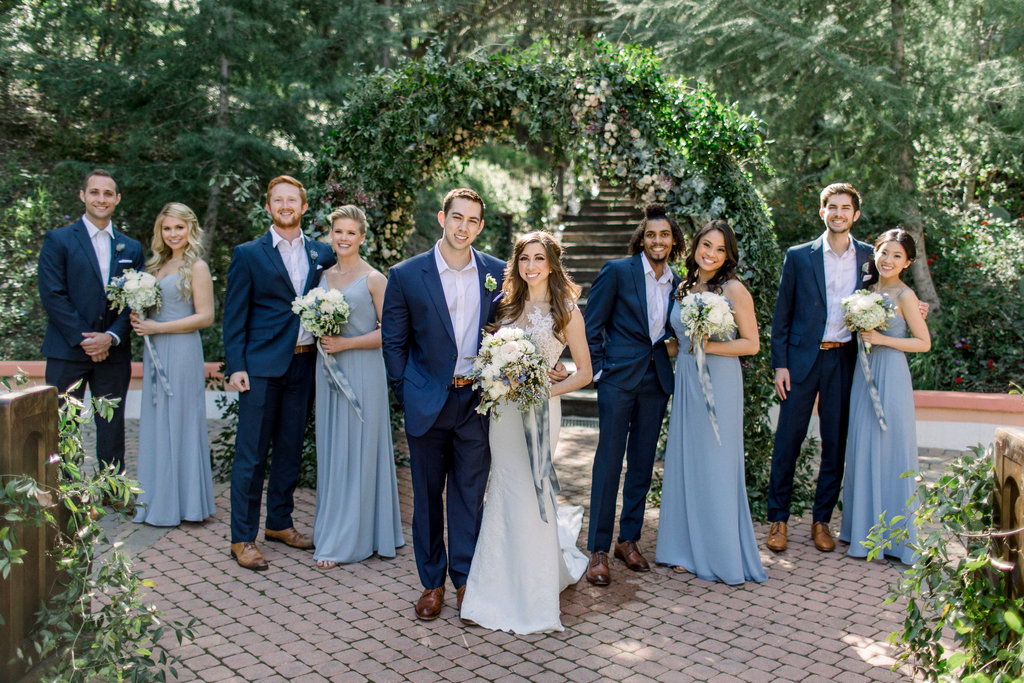 The full bridal party in dusty blue and navy