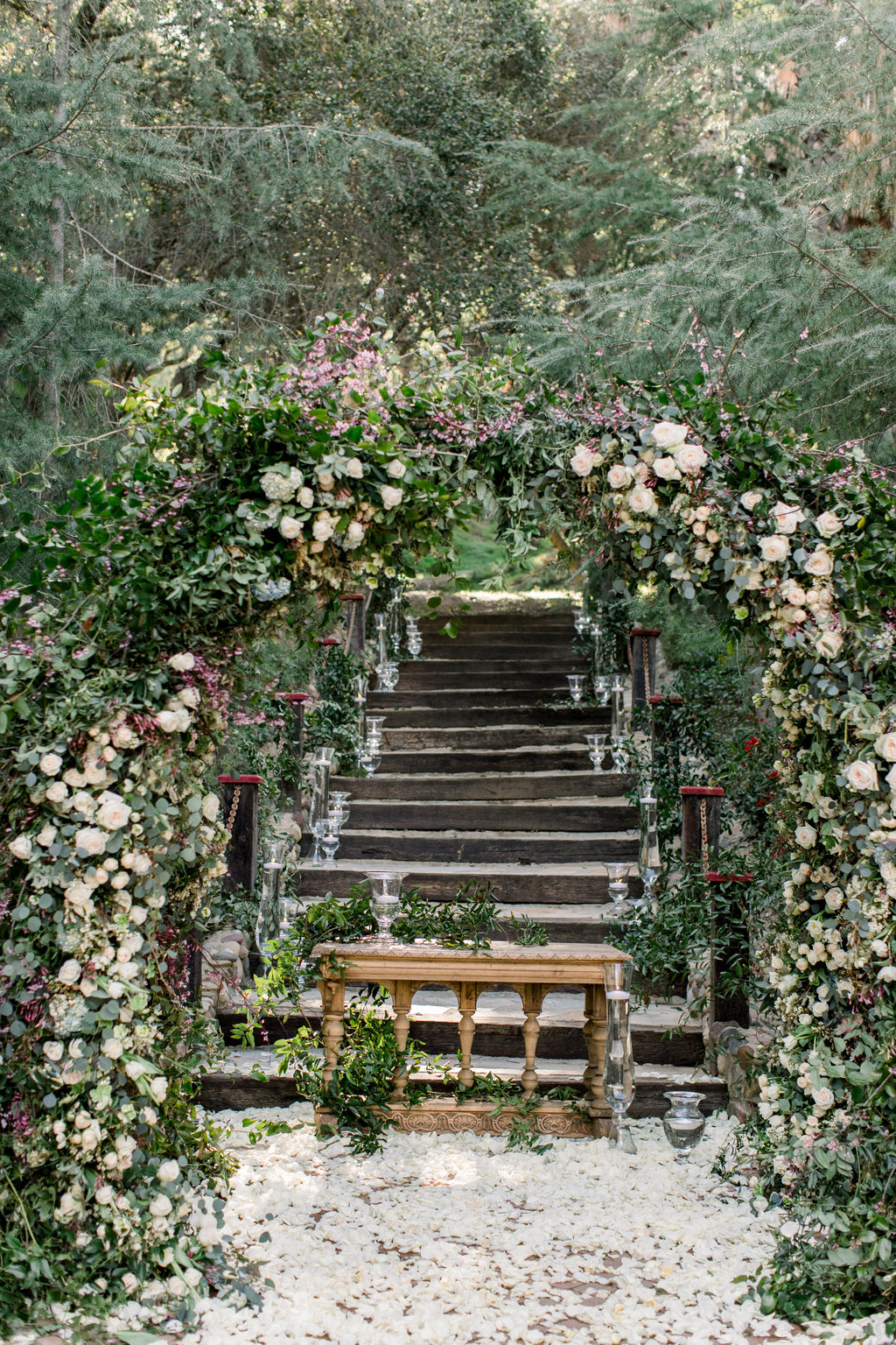 The ceremony arch covered in white blooms