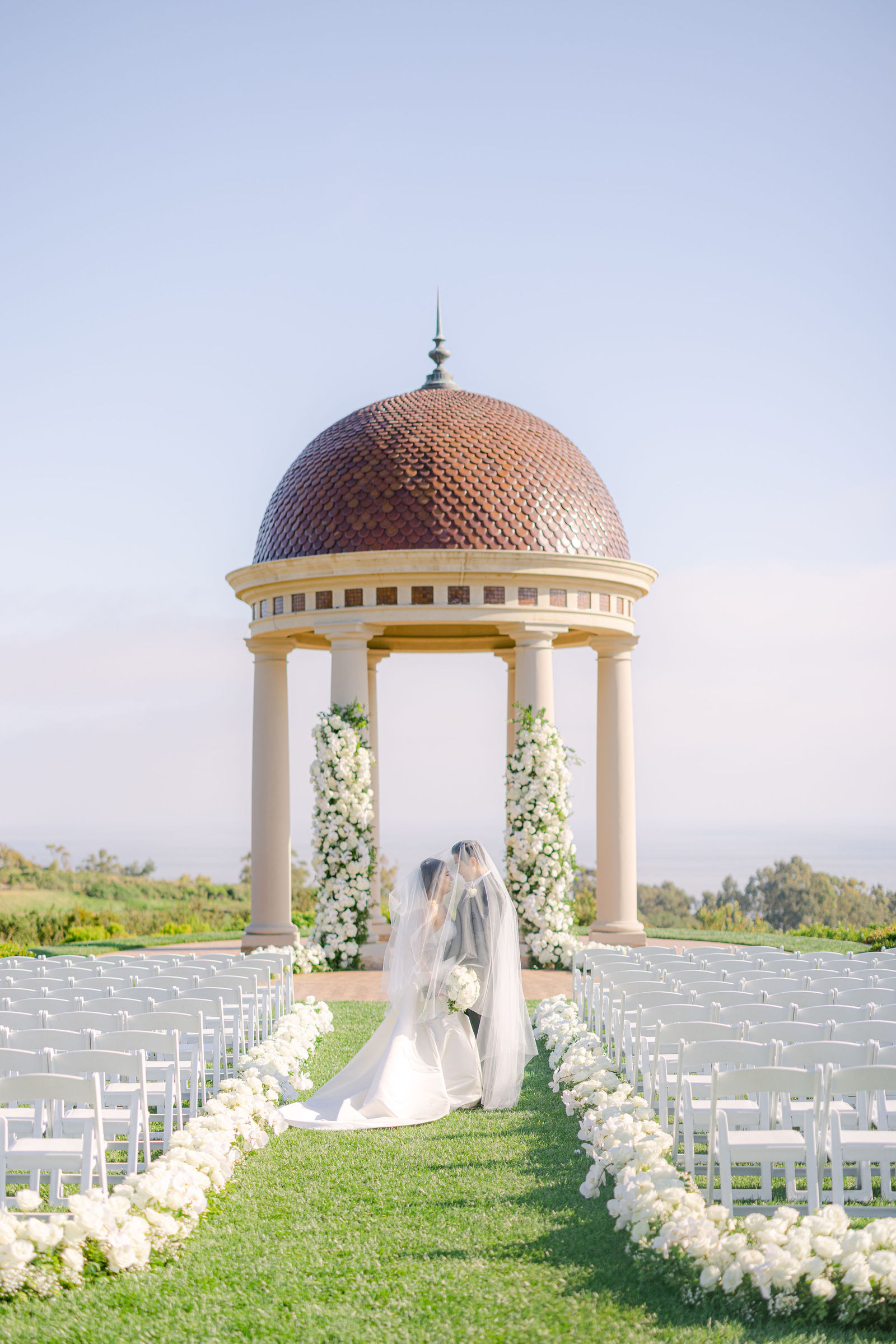 Walking the petal lined aisle to the rotunda at Pelican Hill
