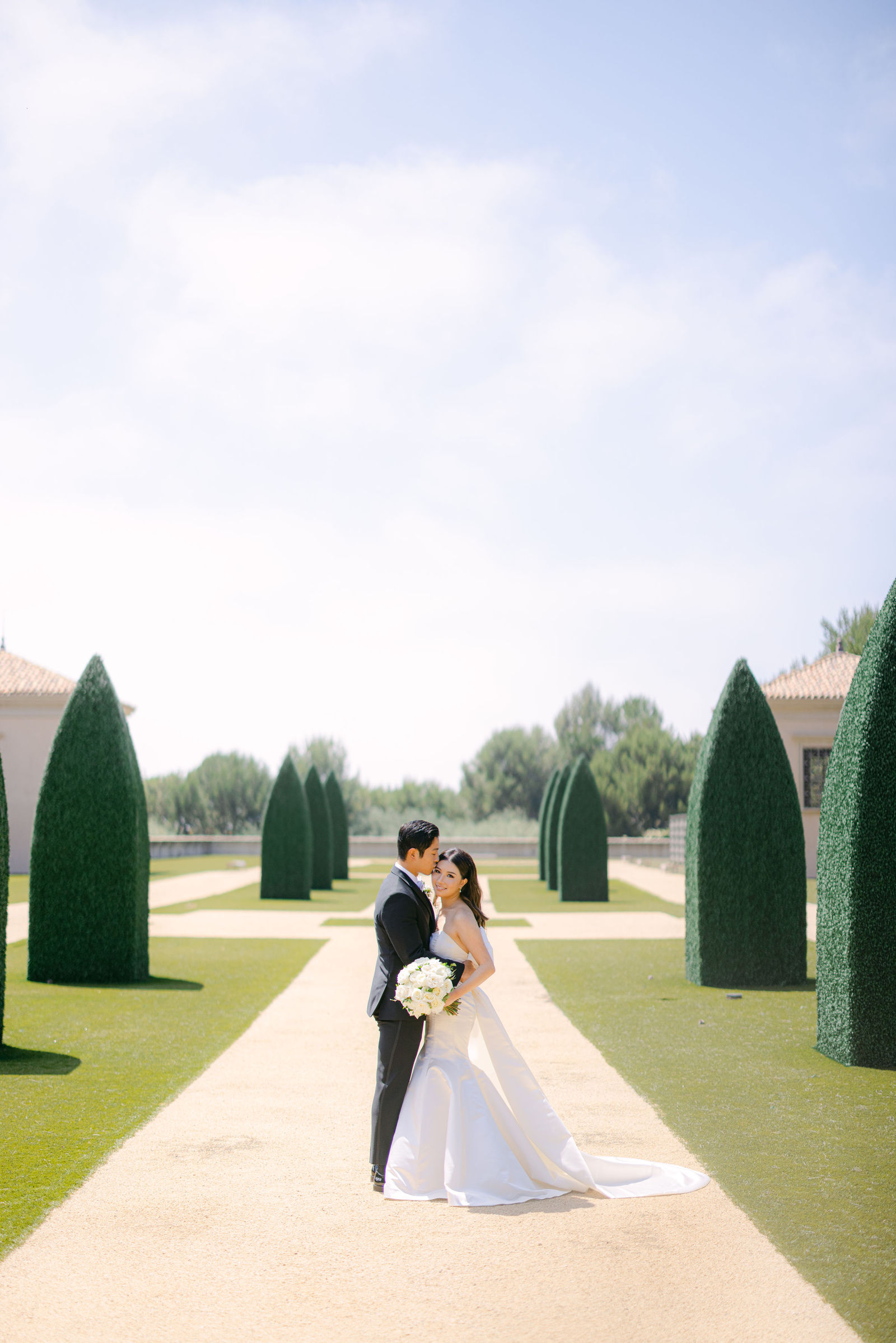 A kiss between the topiaries at Pelican Hill