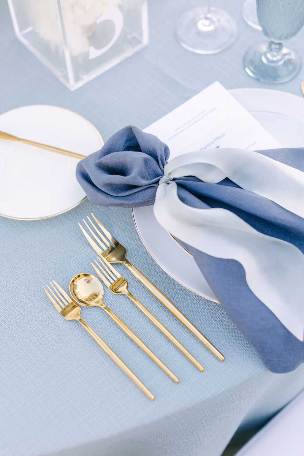 French blue napkins and gold flatware