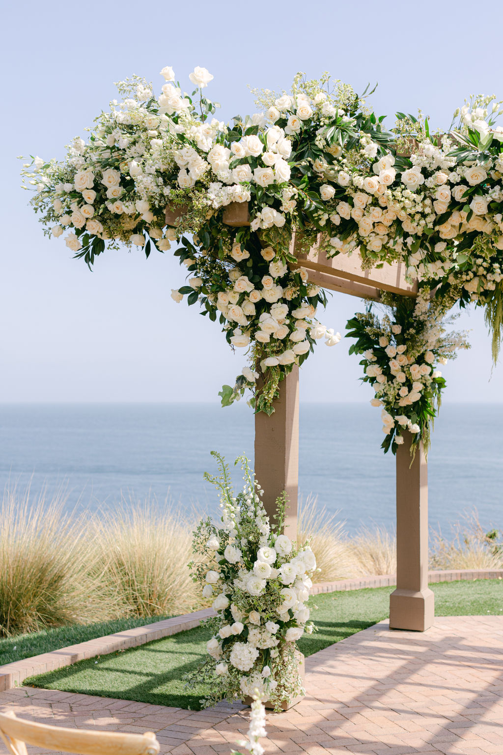 The white floral ceremony arch above the Pacific at Terranea Resort