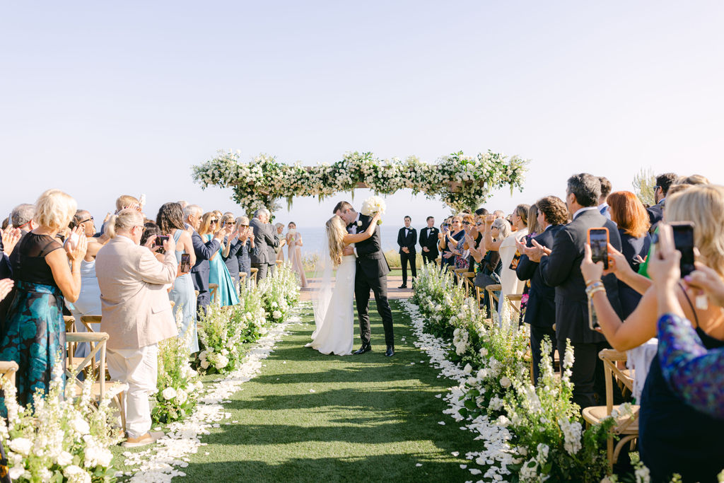 The recessional beneath the floral arch above the Pacific at Terranea