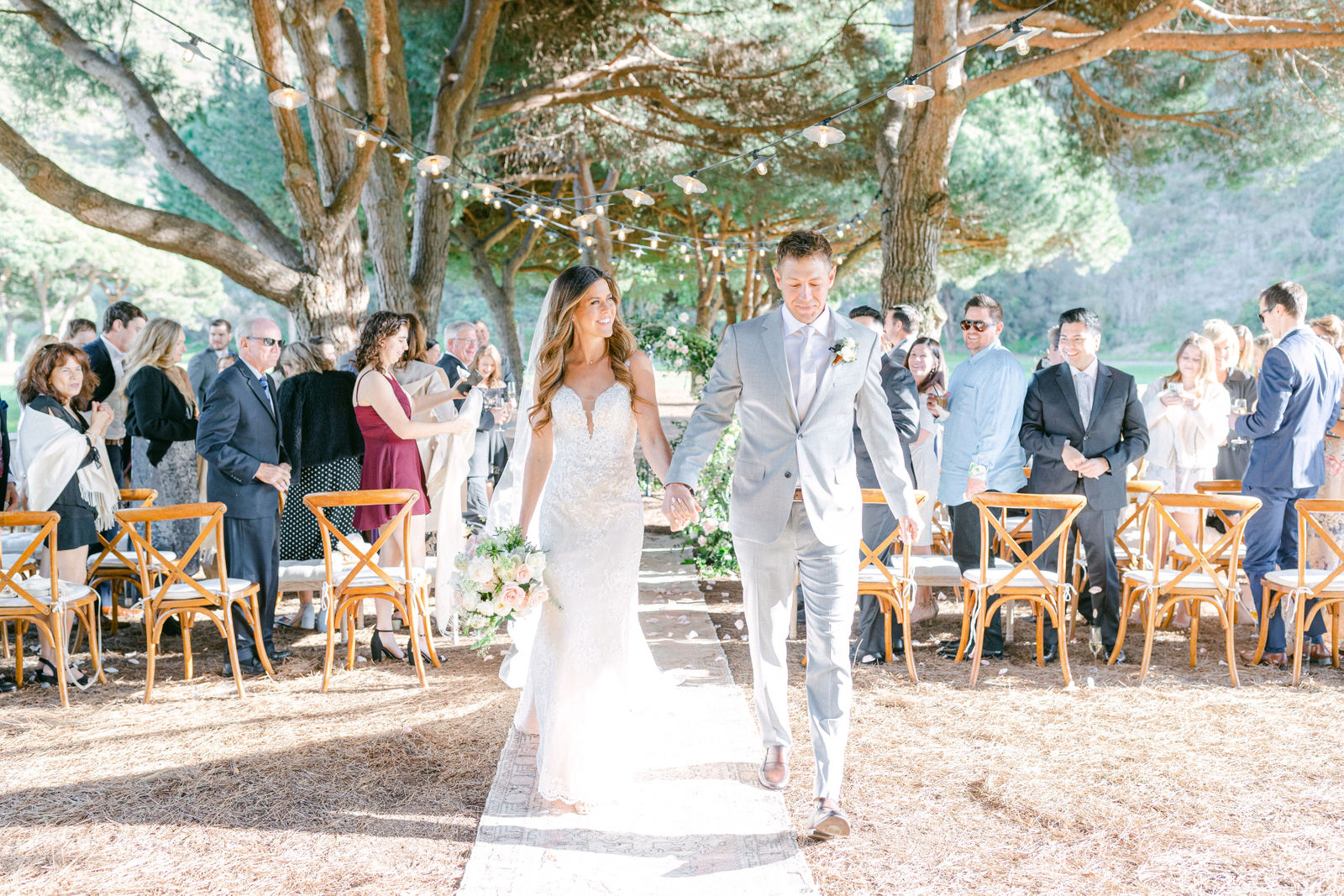 The ceremony at The Ranch at Laguna Beach, guests gathered close beneath the trees