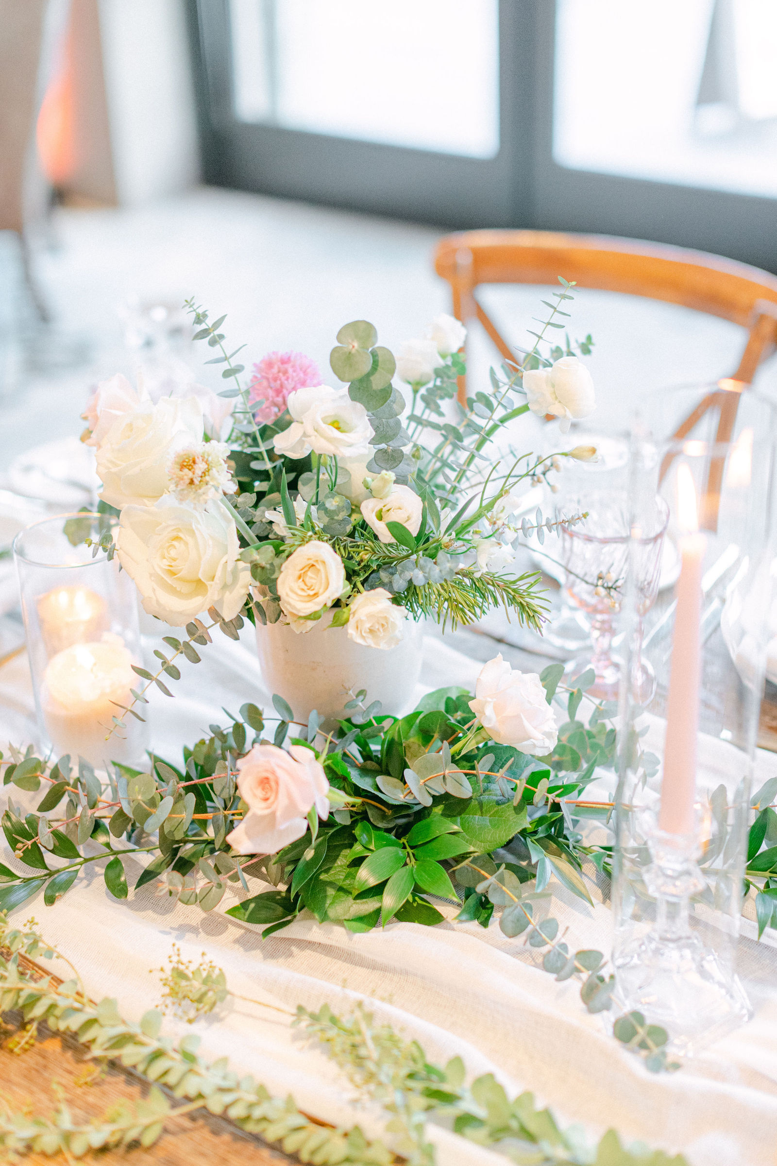 A centerpiece of blush roses and garden greenery