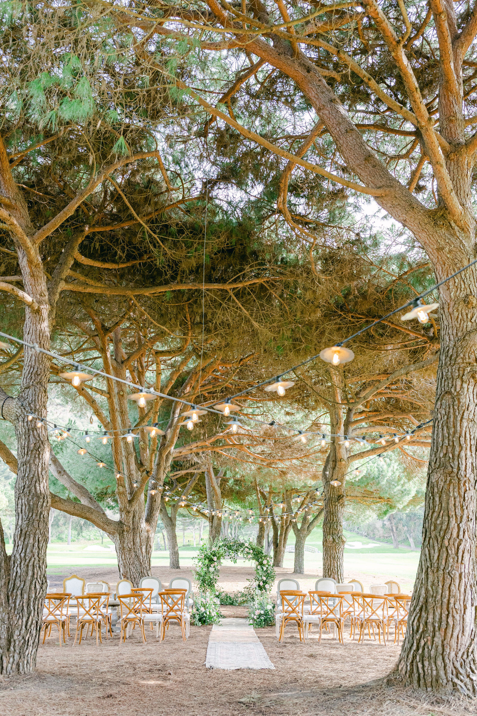 A ceremony aisle beneath the trees at The Ranch at Laguna Beach