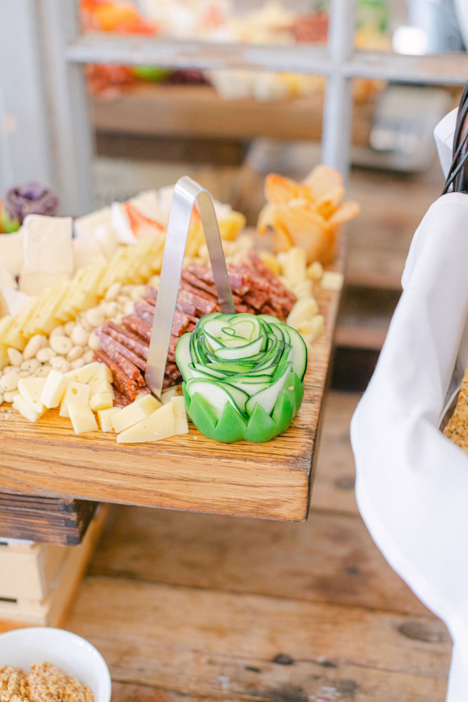 Grazing boards and low bowls of blush roses at cocktail hour