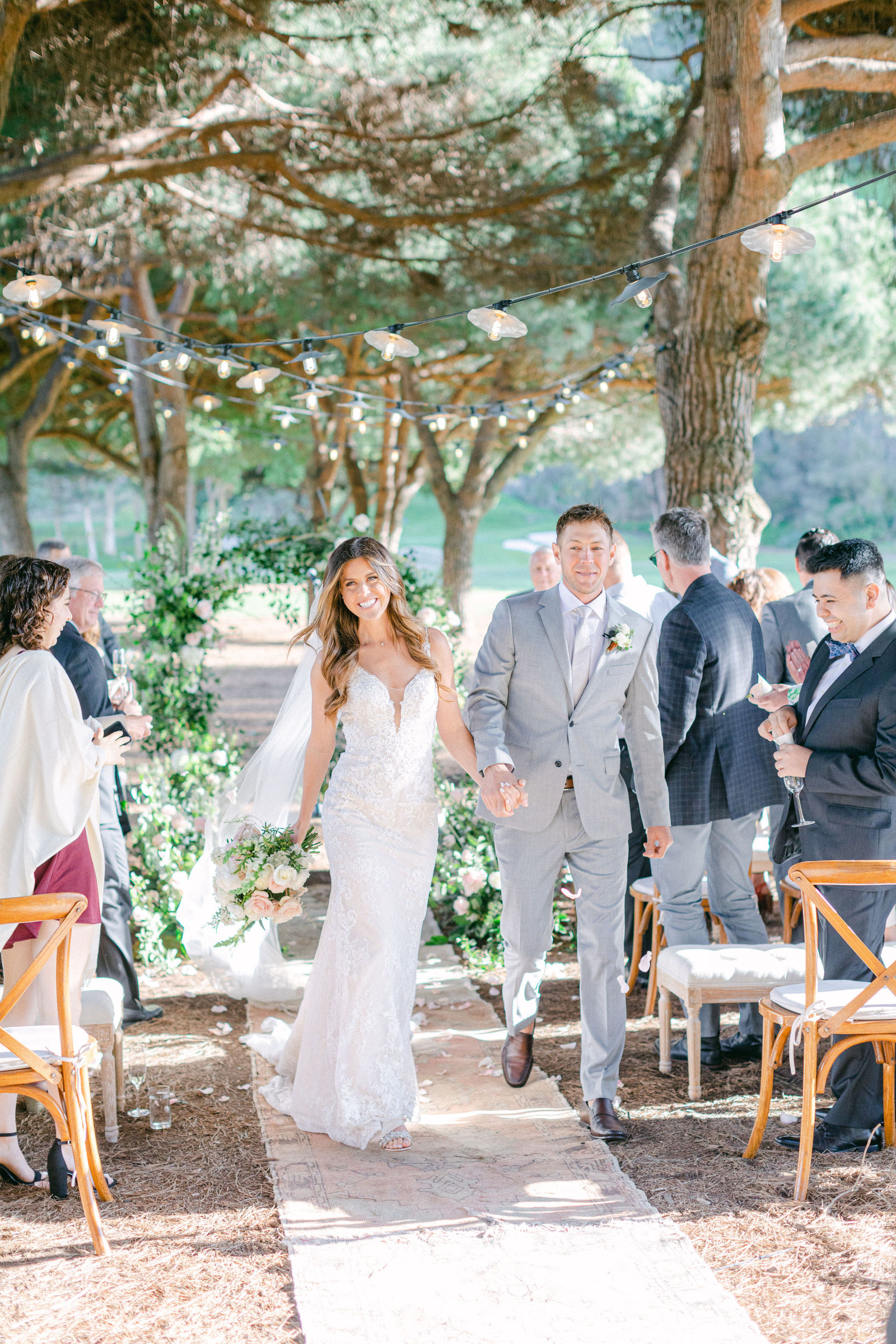The ceremony at The Ranch at Laguna Beach, guests gathered close beneath the trees