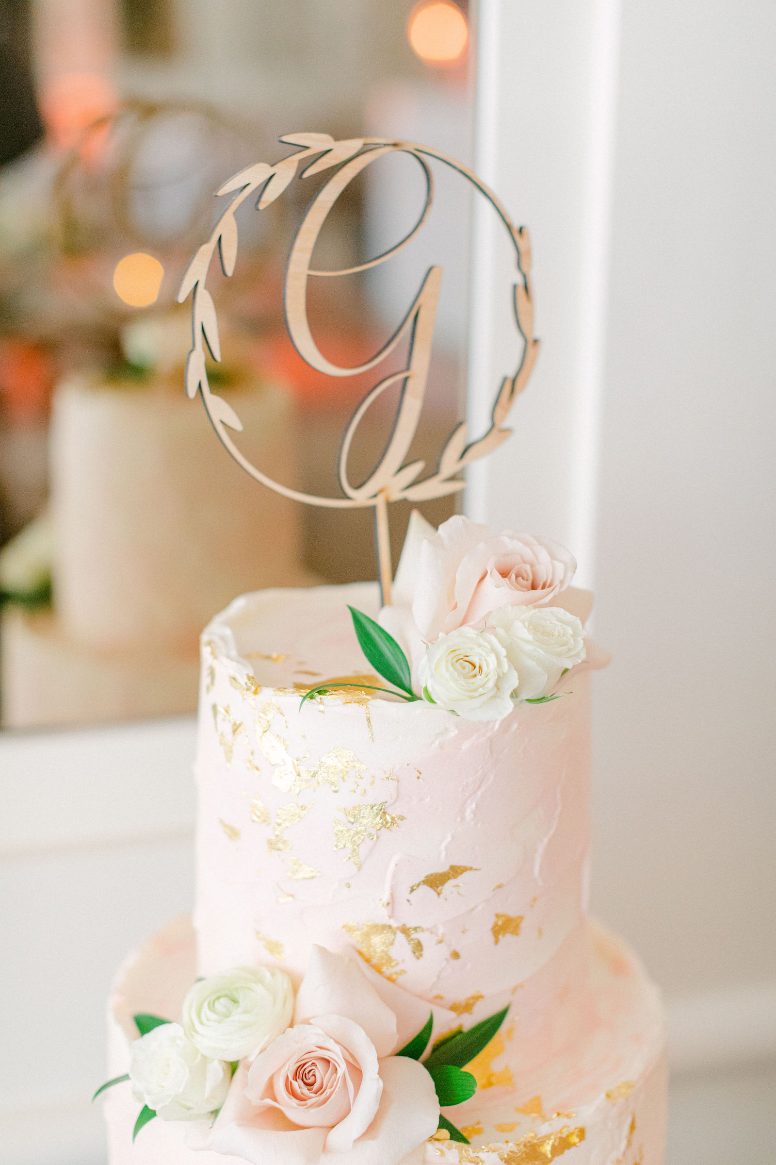 The wedding cake with a monogram topper