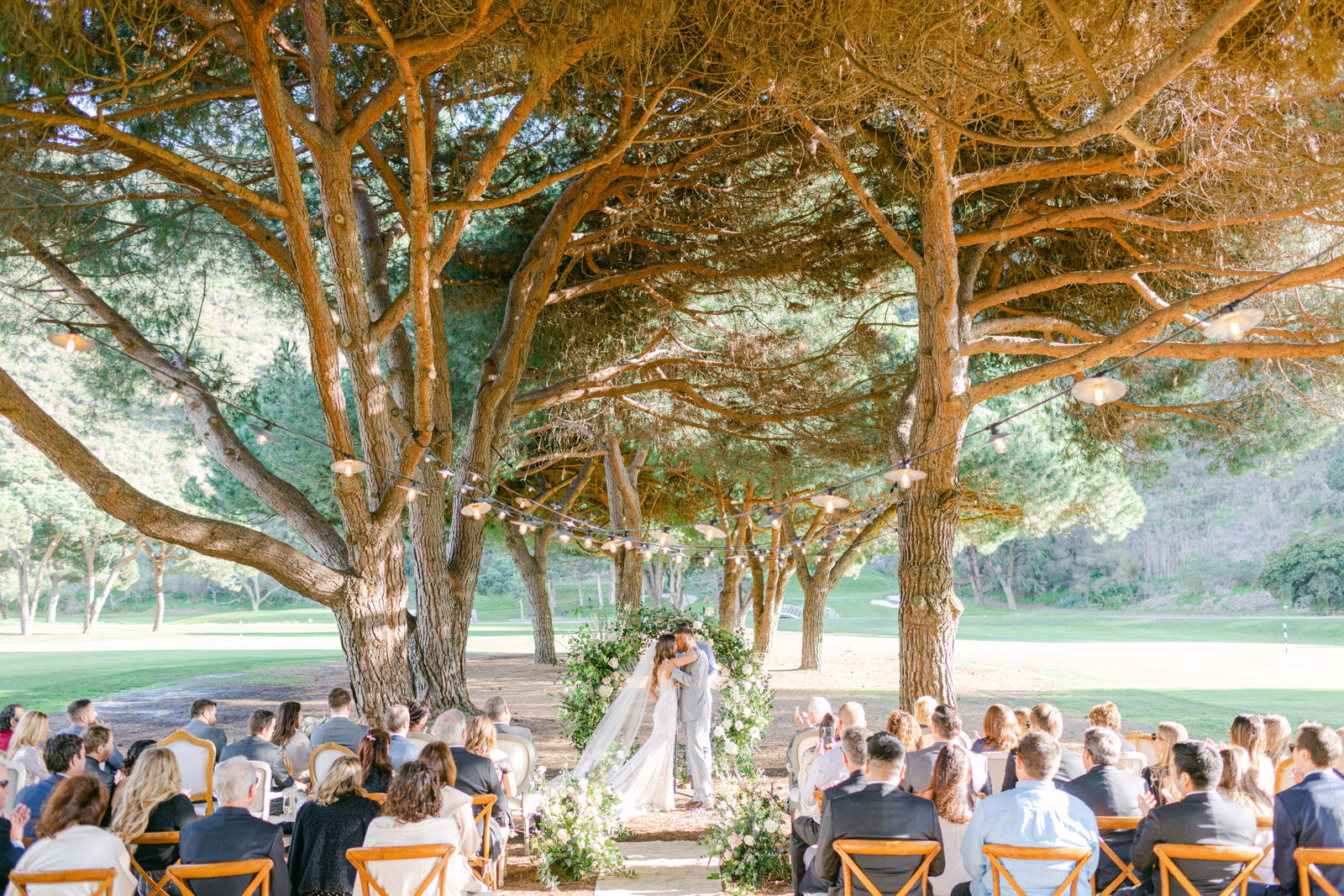 The ceremony aisle beneath the trees at The Ranch at Laguna Beach