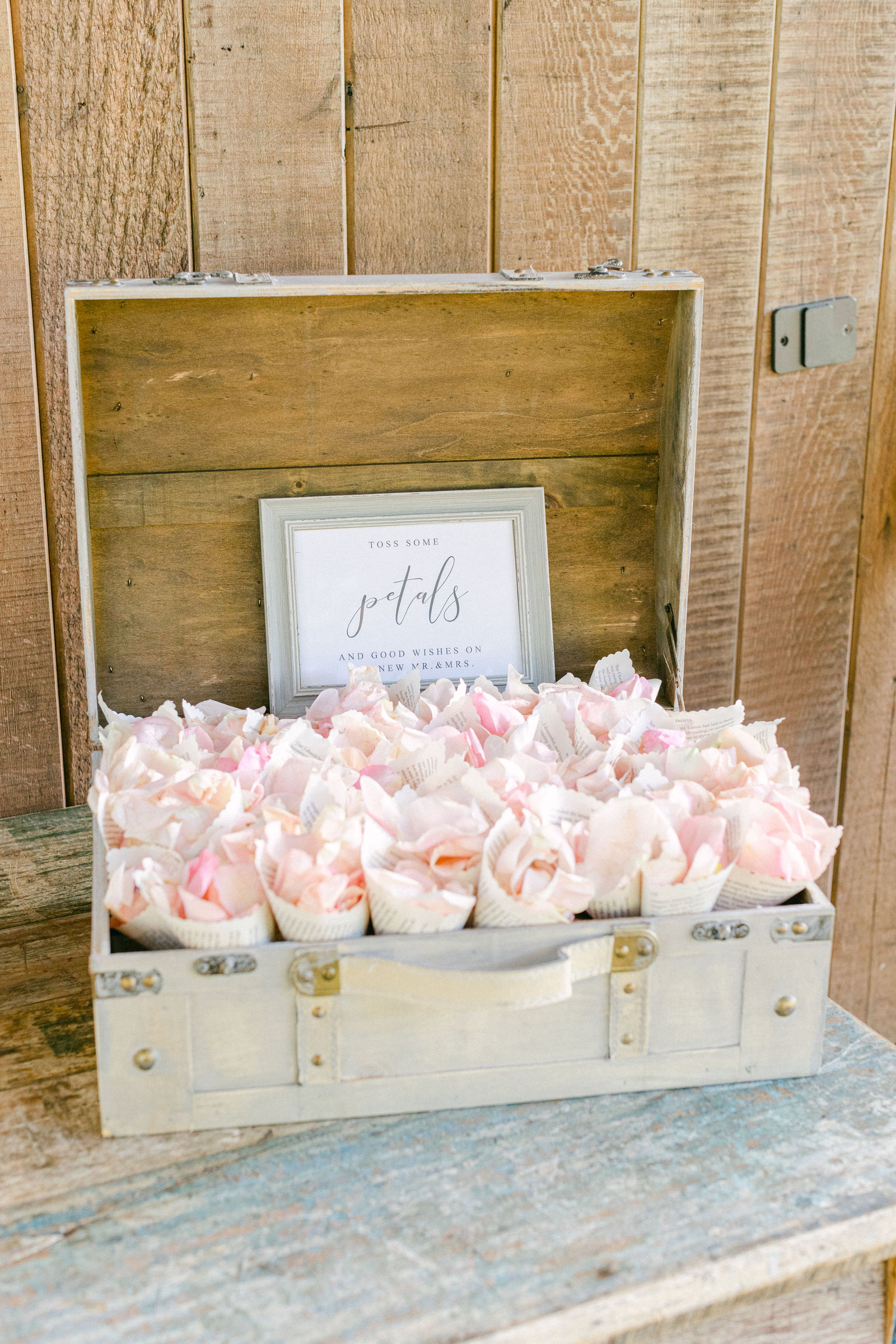 The escort card display, blush roses in a wooden box