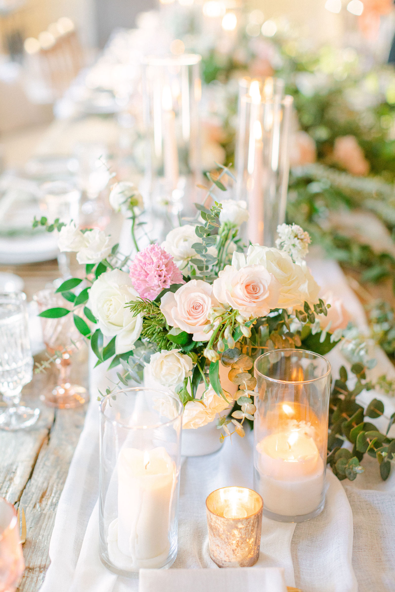 Tapers and blush florals down the length of the table