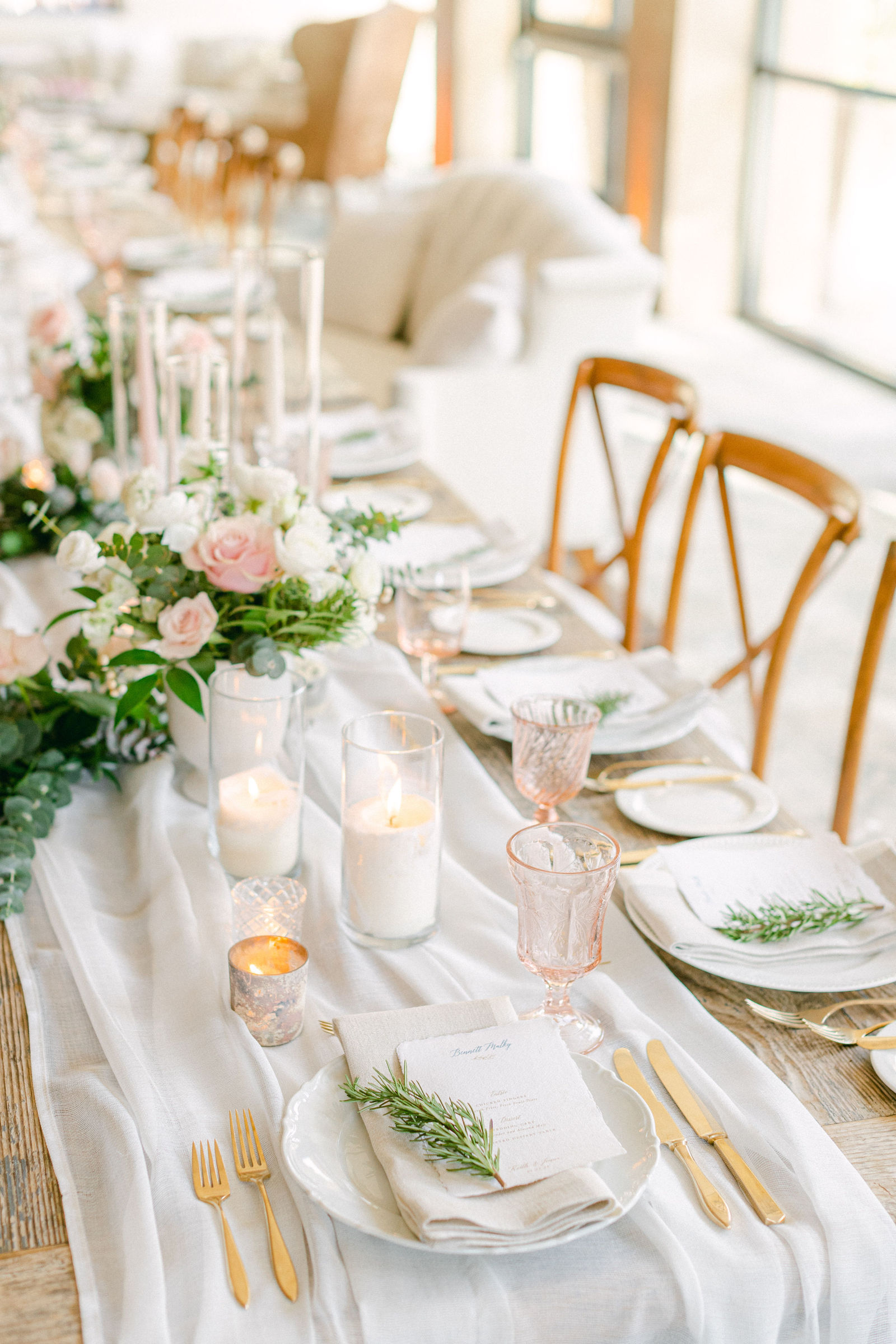 Candlelight and greenery down the reception table