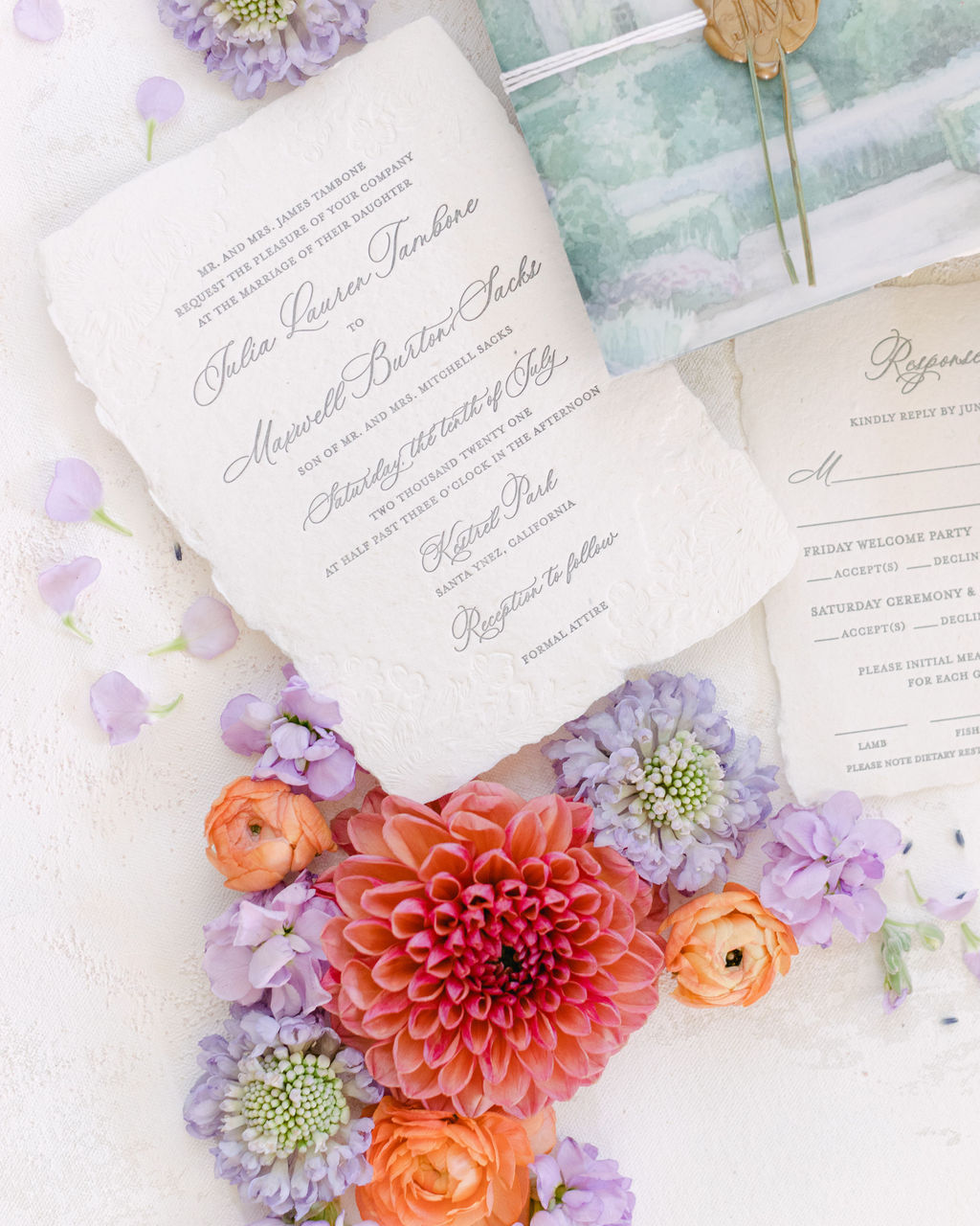 Invitation suite laid among garden blooms