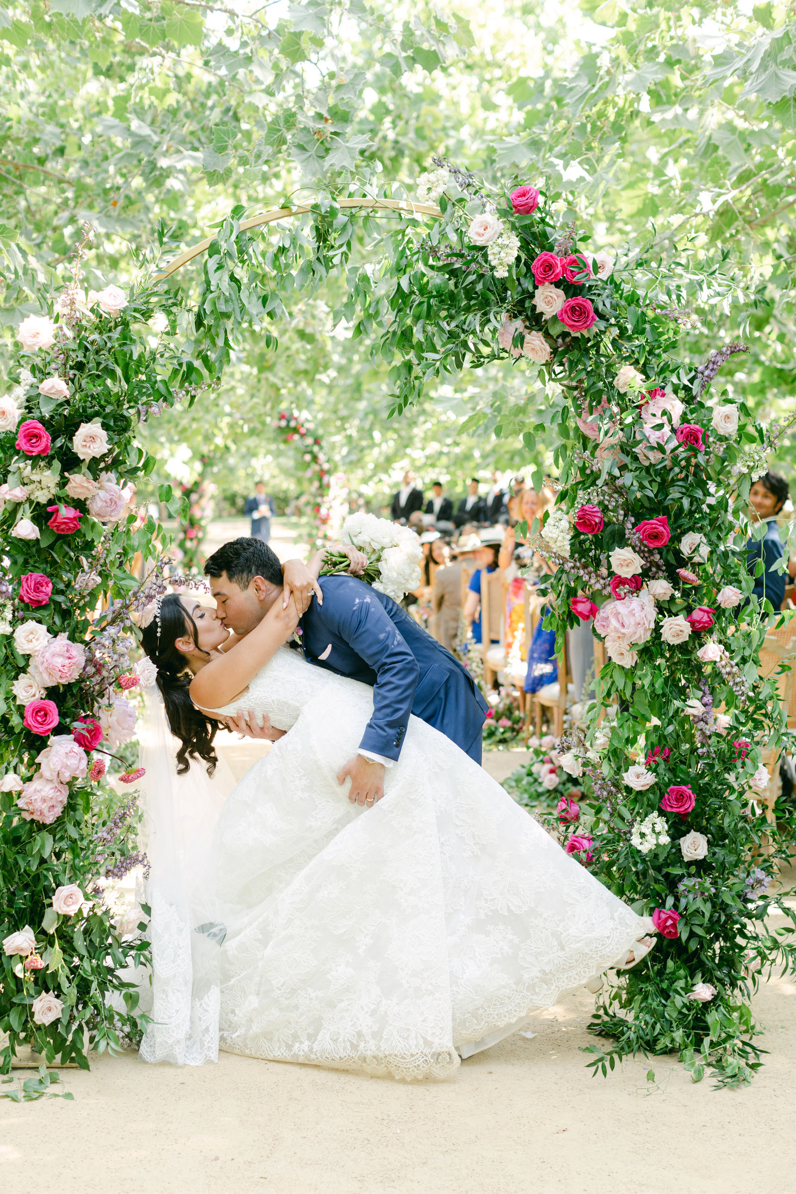 The dip kiss beneath the floral arch at Kestrel Park
