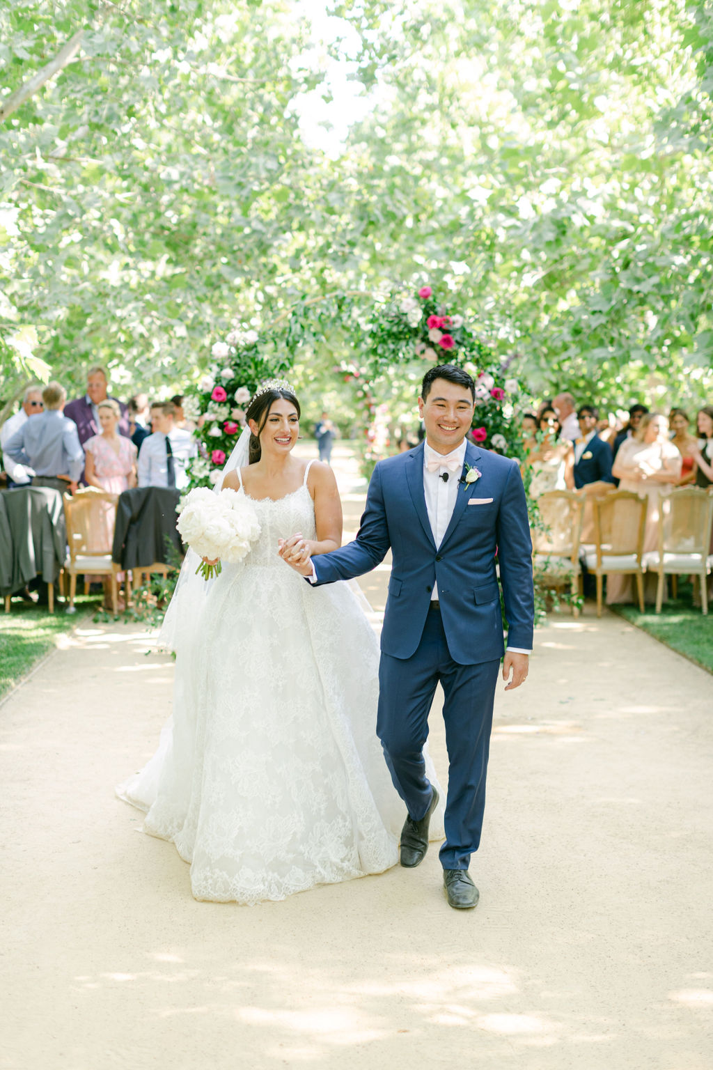 Julia and Maxwell walking back up the aisle
