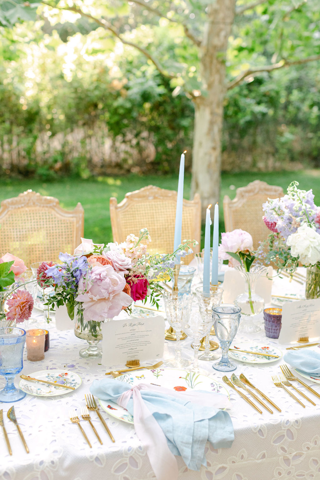 Peonies and taper candles on the reception table
