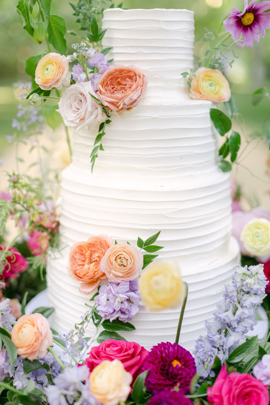 Cake detail with ranunculus and summer citrus tones