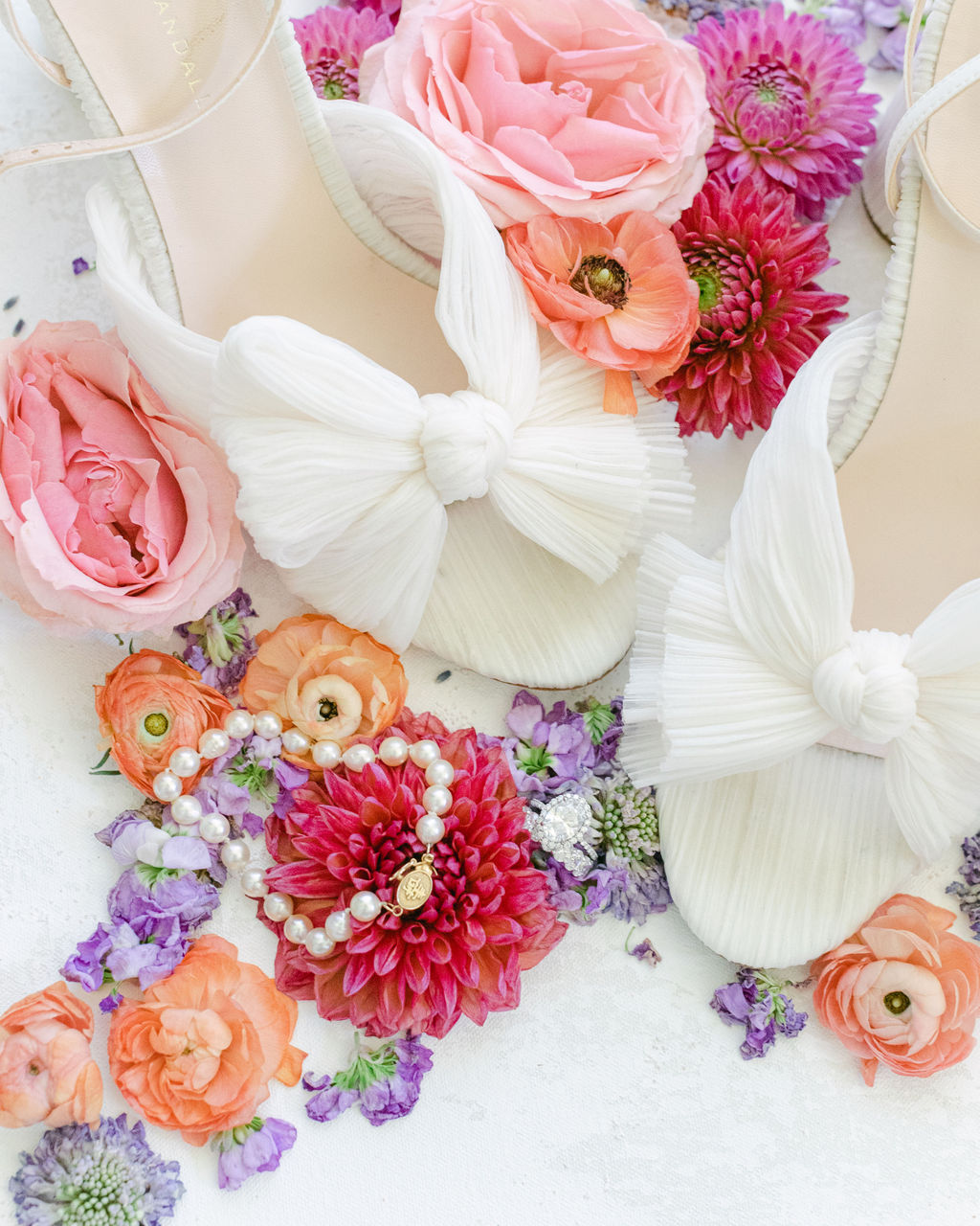 Heirloom jewelry and silk bows laid out before the ceremony