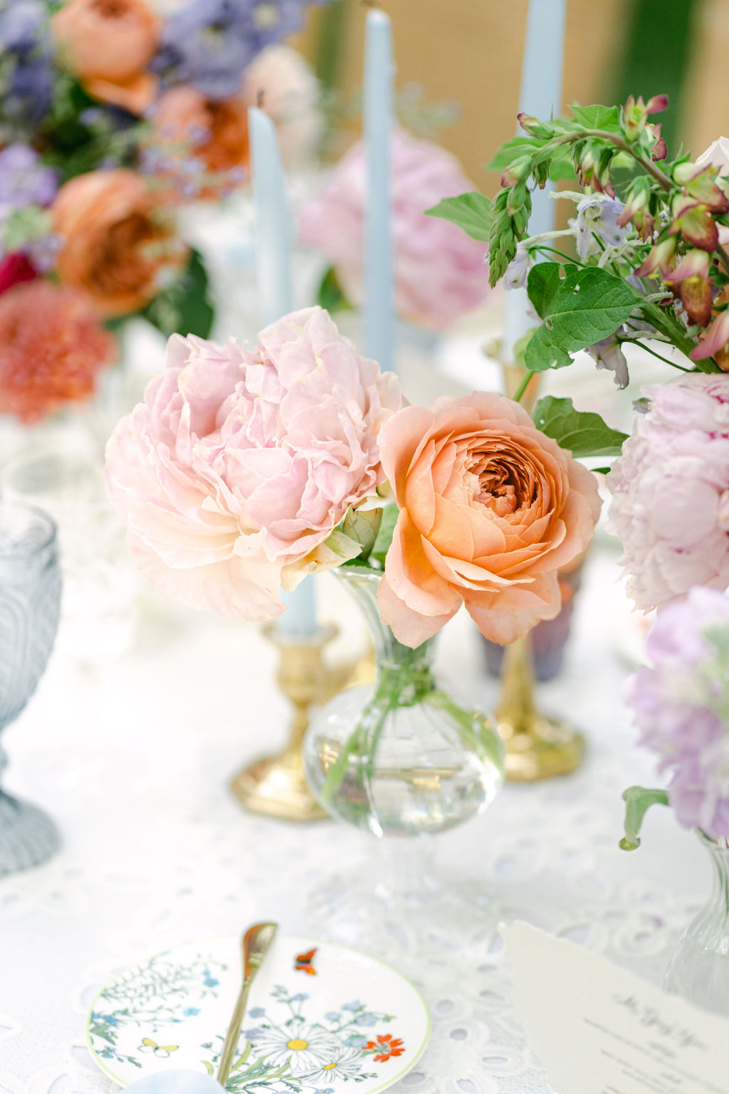 Coral garden roses in bud vases