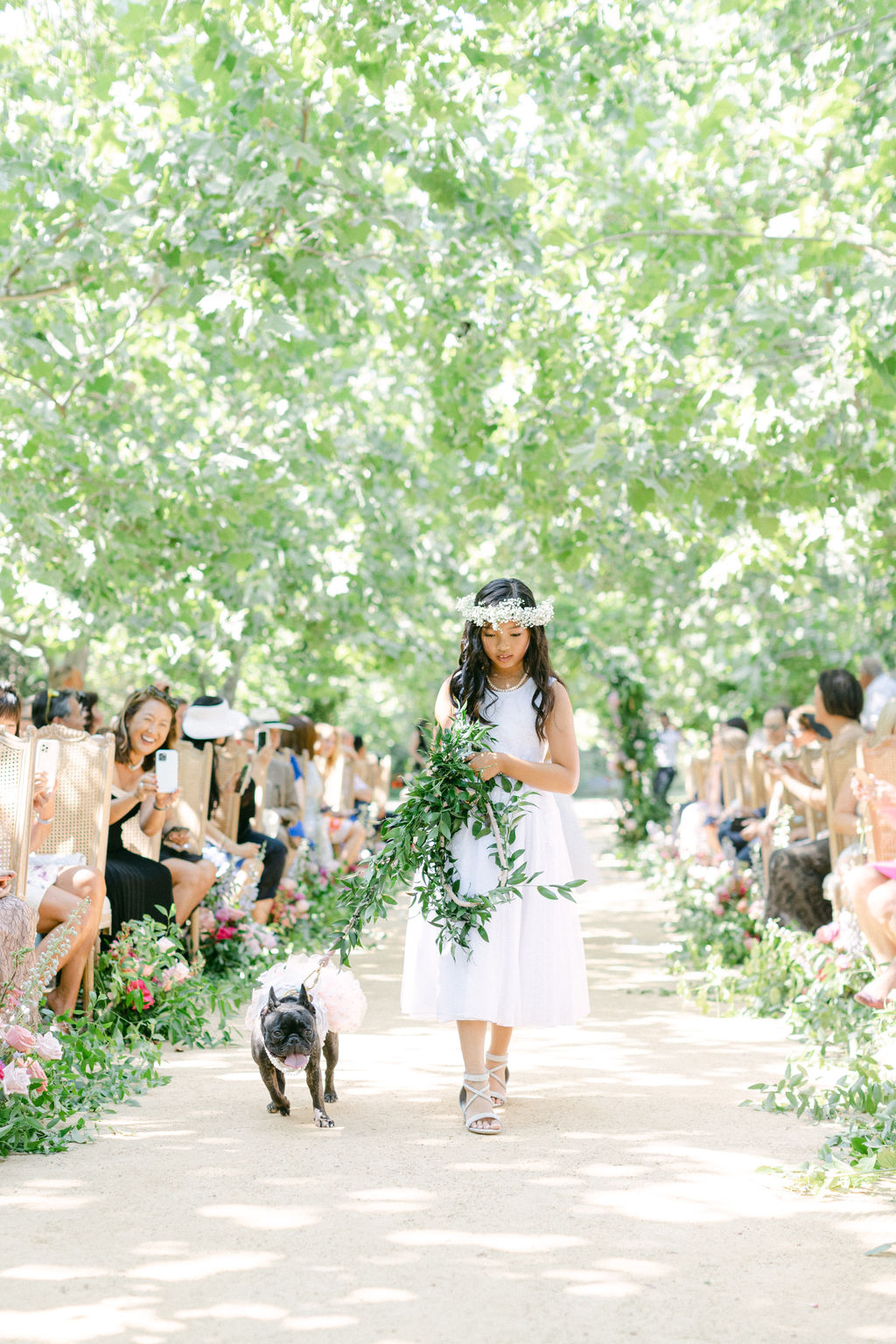The flower girl and the couple's French bulldog walking the aisle at Kestrel Park