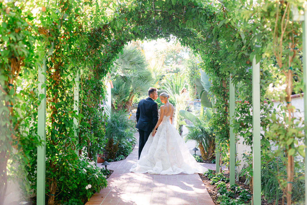 Through the green arch in the gardens
