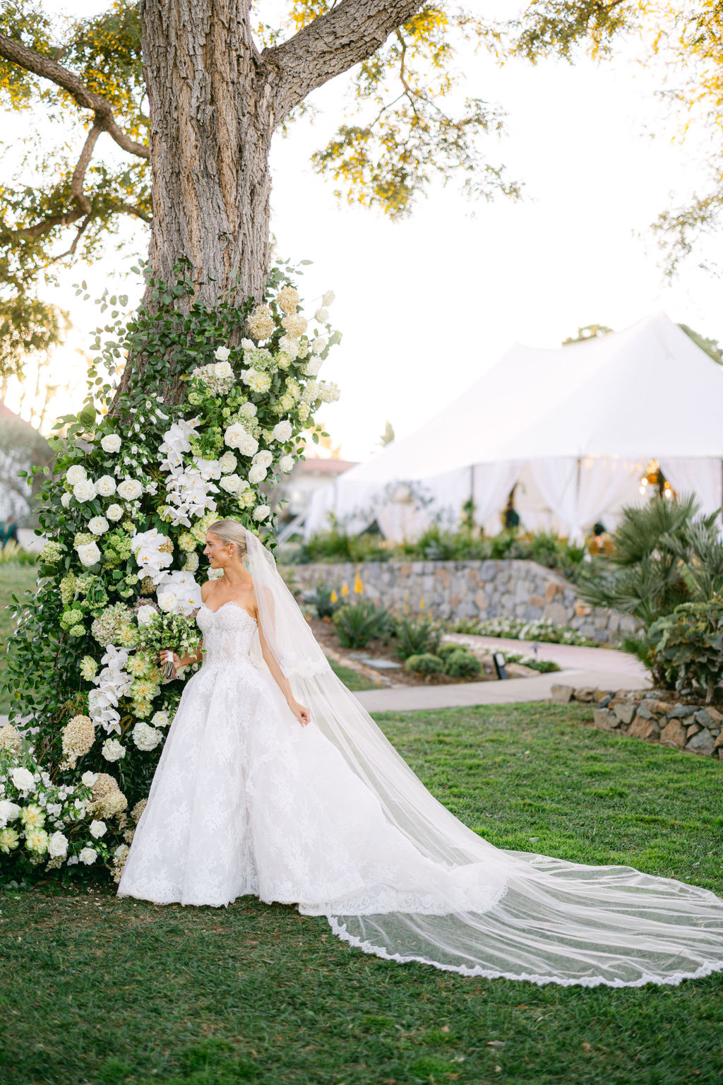 The bride beside a white orchid installation at the Inn at Rancho Santa Fe