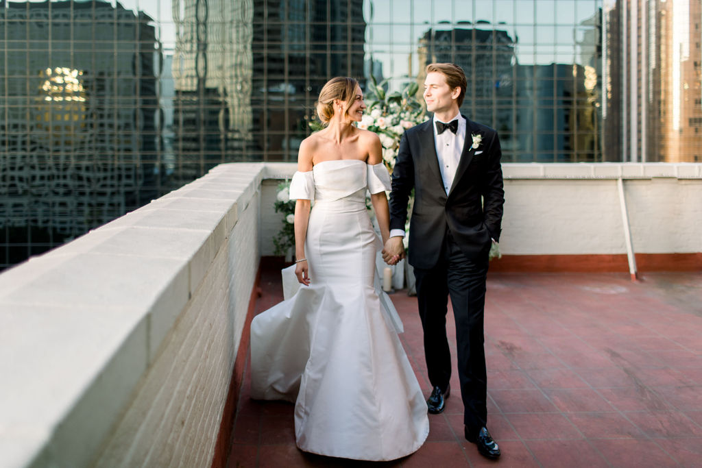 Bride and groom at the flower wall