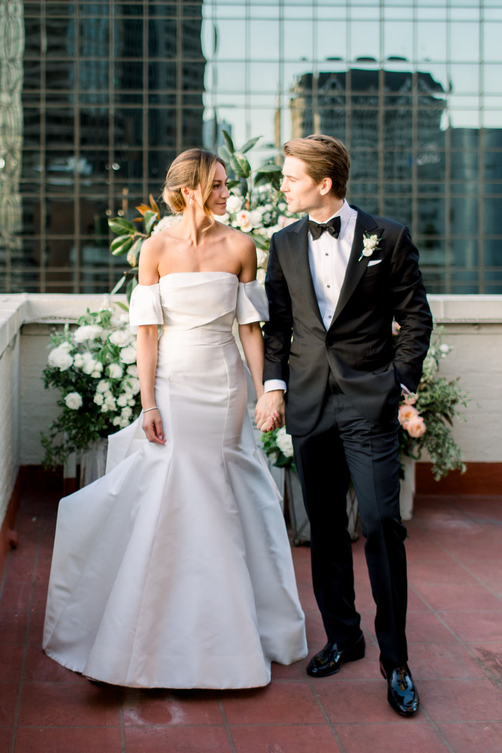 The gown at full length, downtown skyline behind