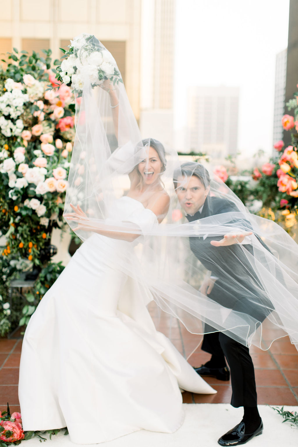 Laughing beneath the veil on the rooftop at the Jonathan Club