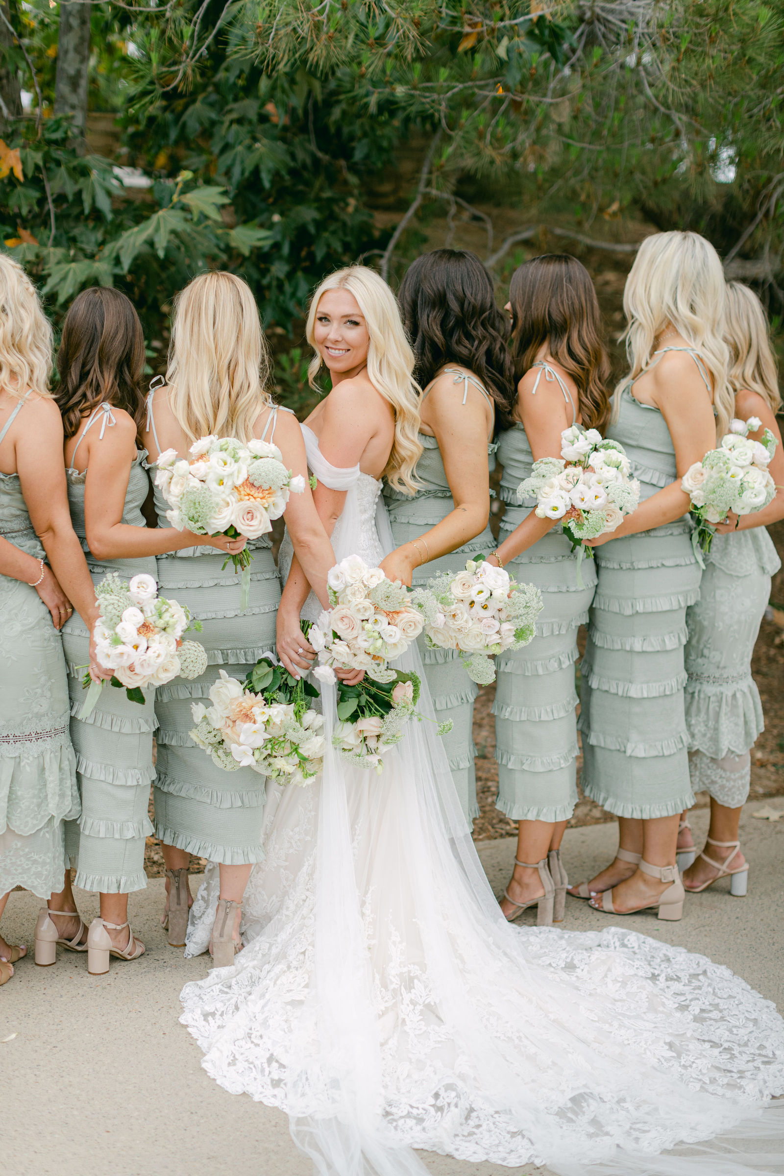The bridal party in sage and black tie before the ceremony