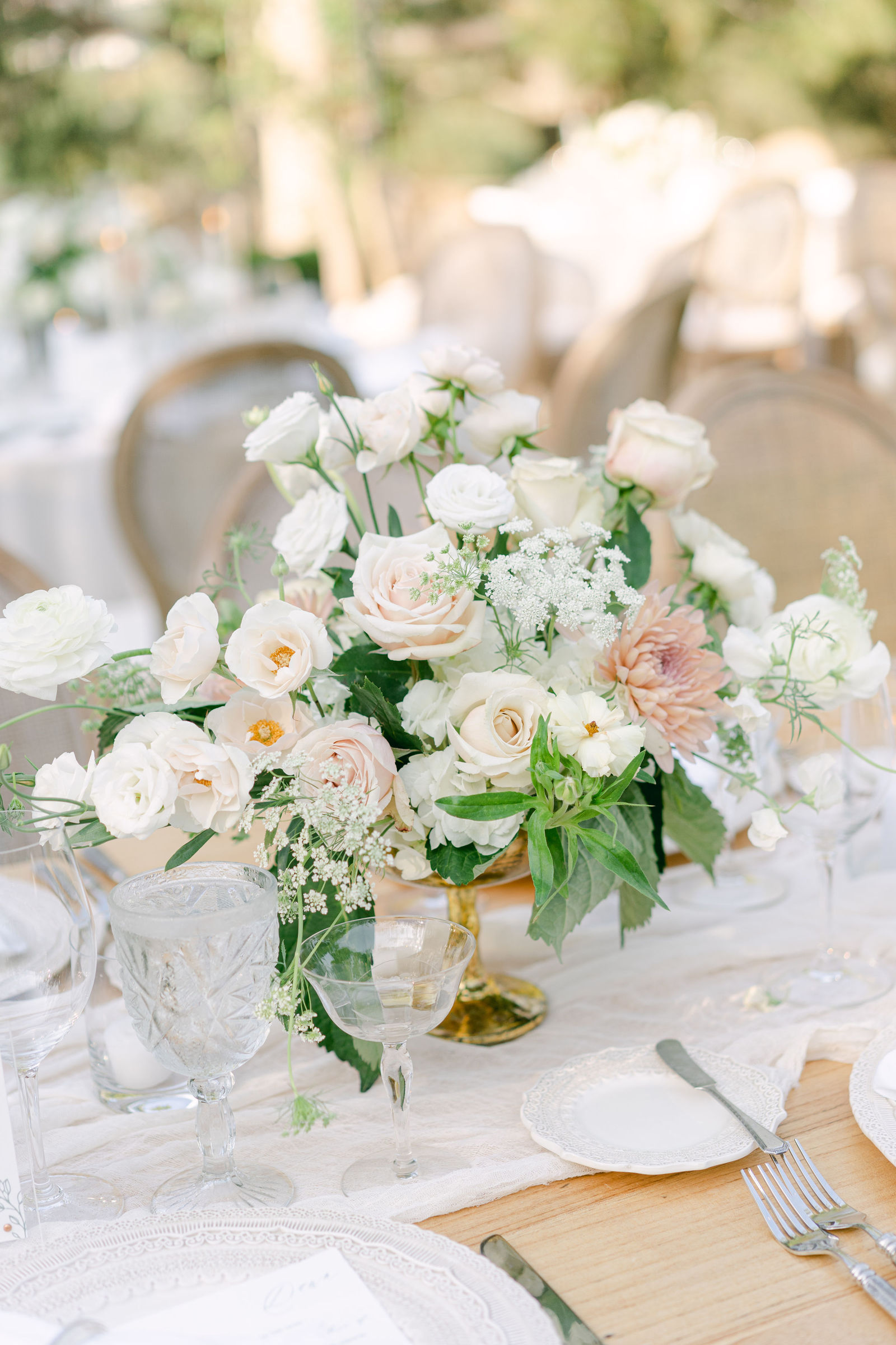 Centerpieces of garden roses and peach dahlias