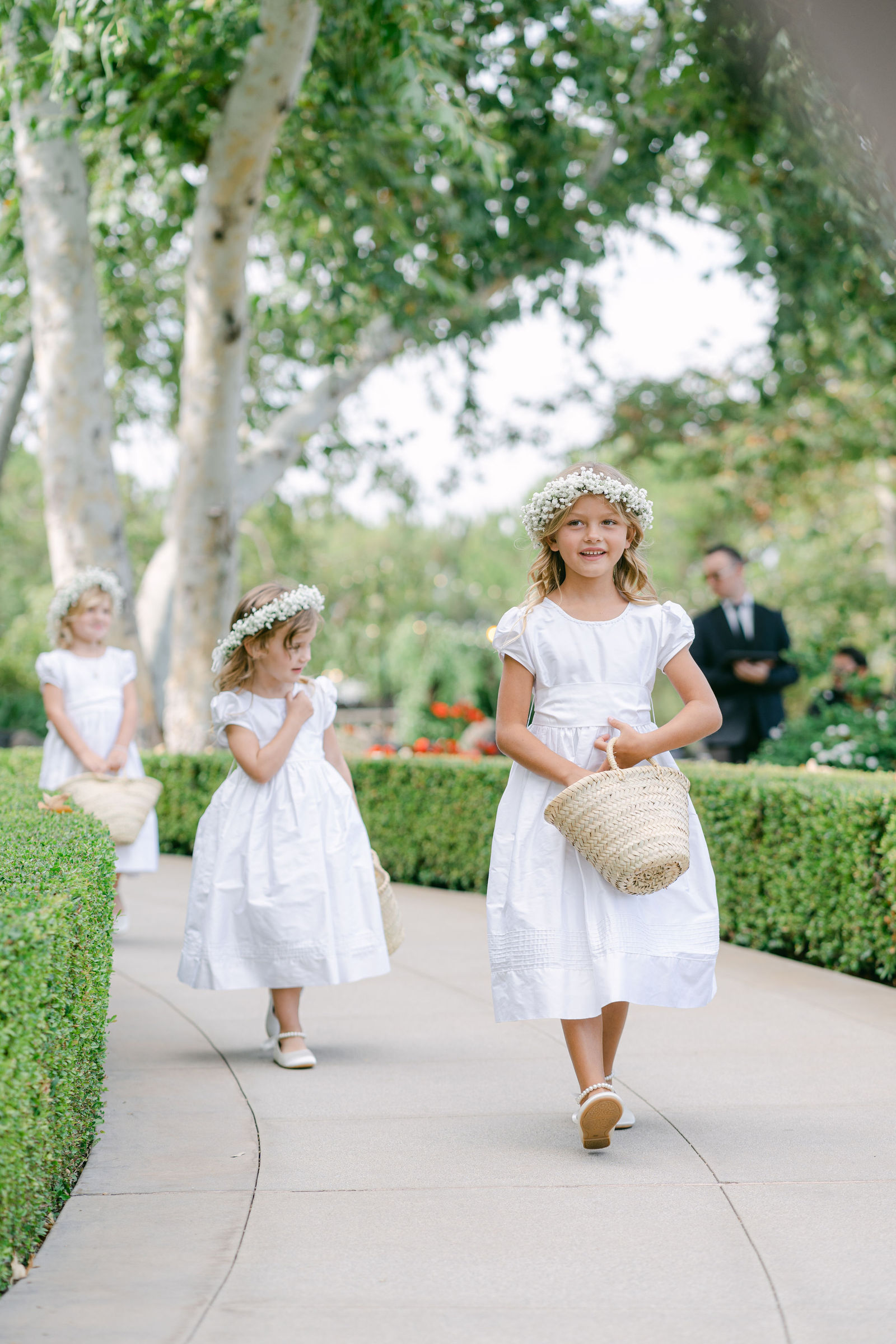 The groom and the children coming up the petal aisle