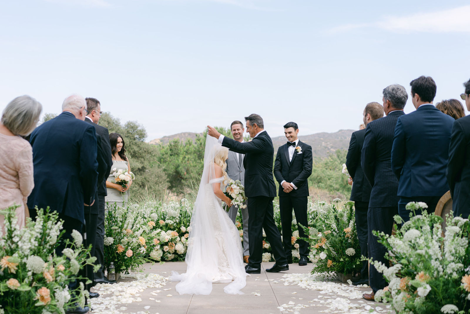 Vows on the terrace, the hills behind them