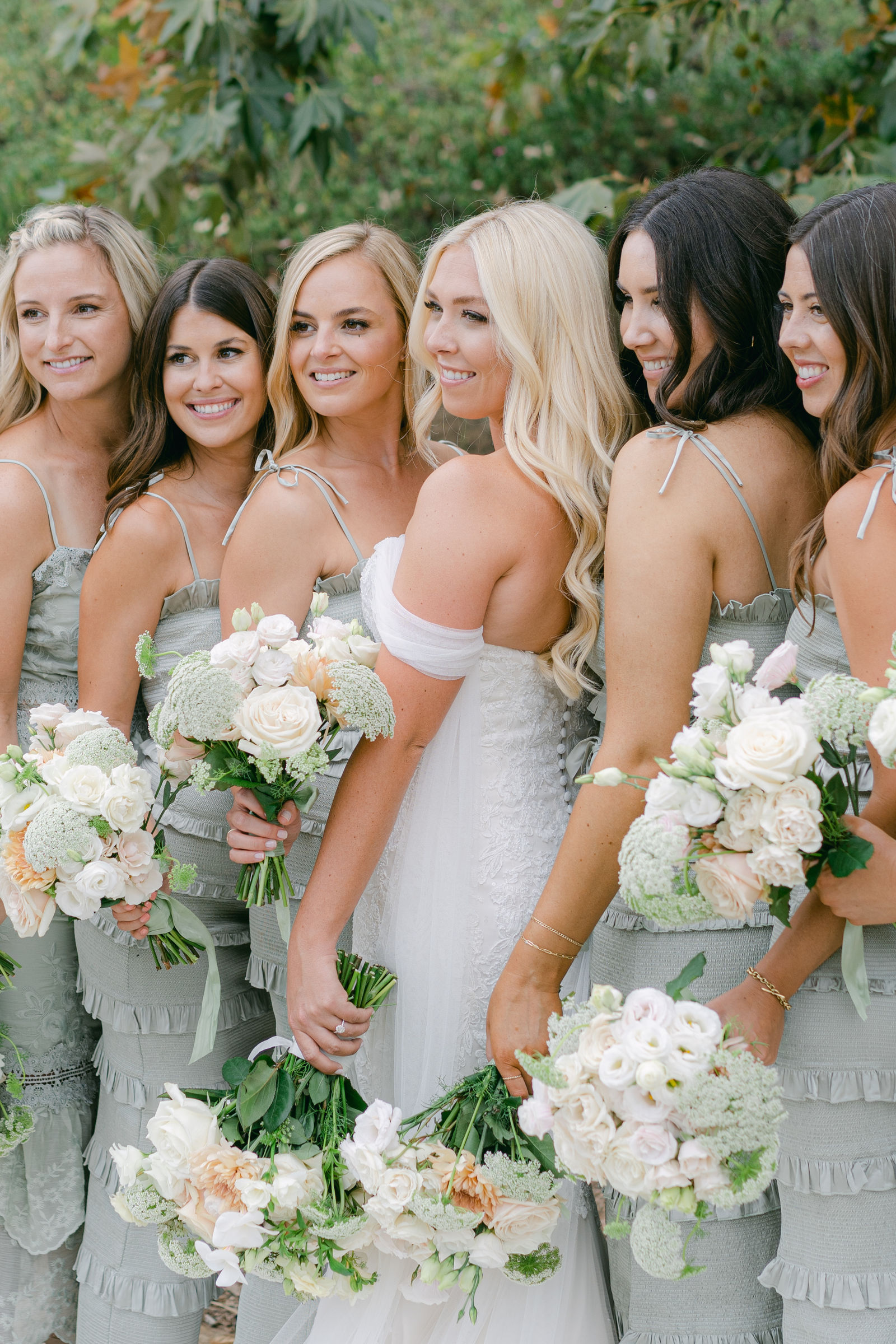 The bridal party in sage and black tie before the ceremony