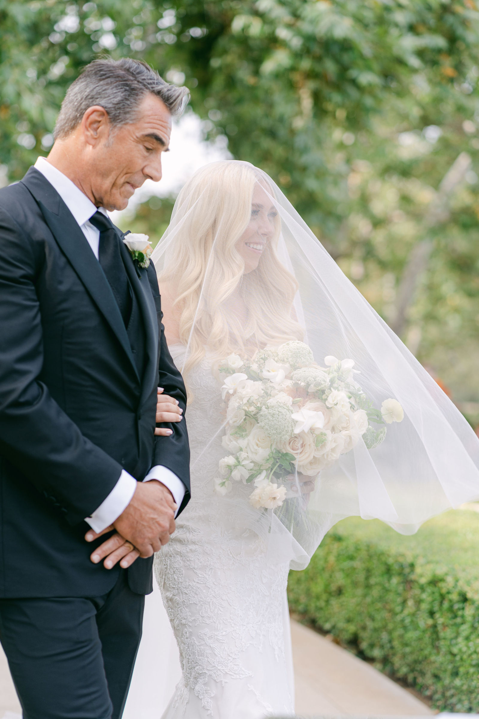 Her father walking her up the petal aisle, veil over her face