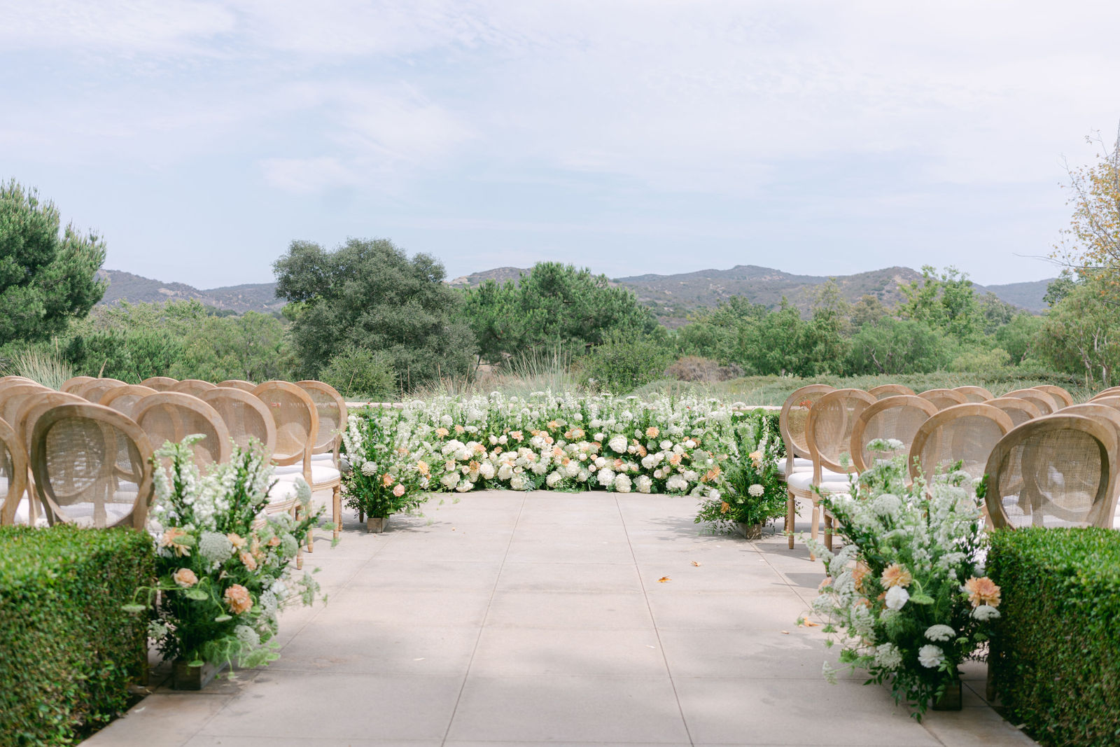 Bridesmaids in sage with white and peach bouquets