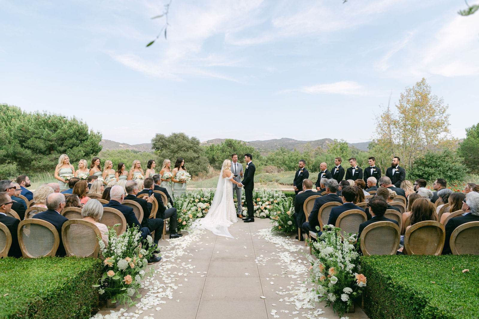 Vows on the terrace, the hills behind them