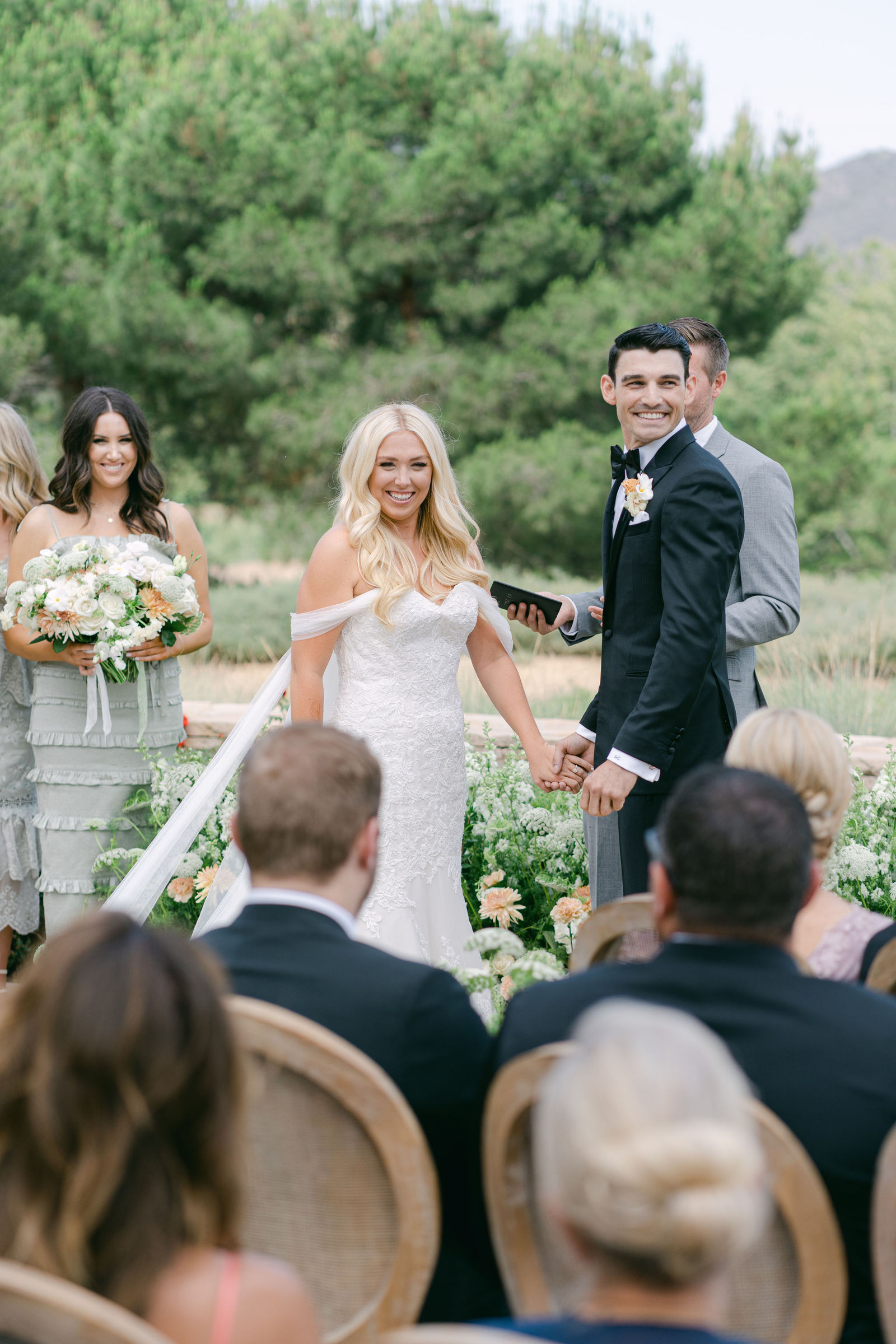 Vows on the terrace, the hills behind them