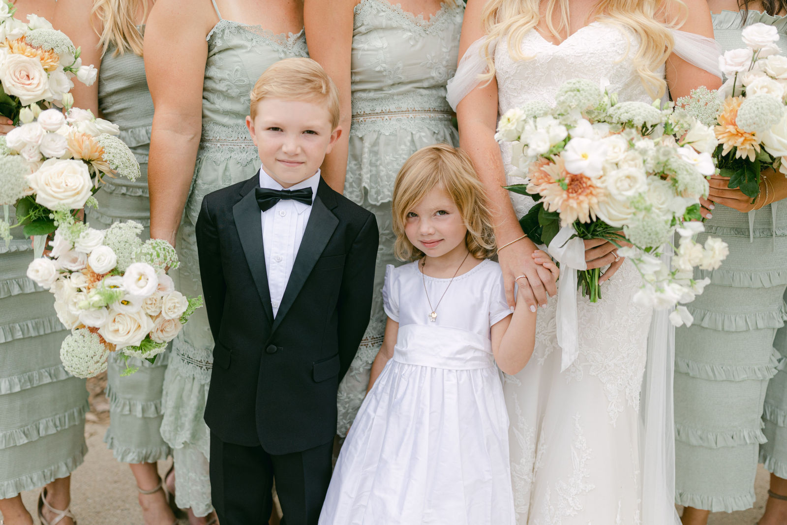 The bridal party in sage and black tie before the ceremony