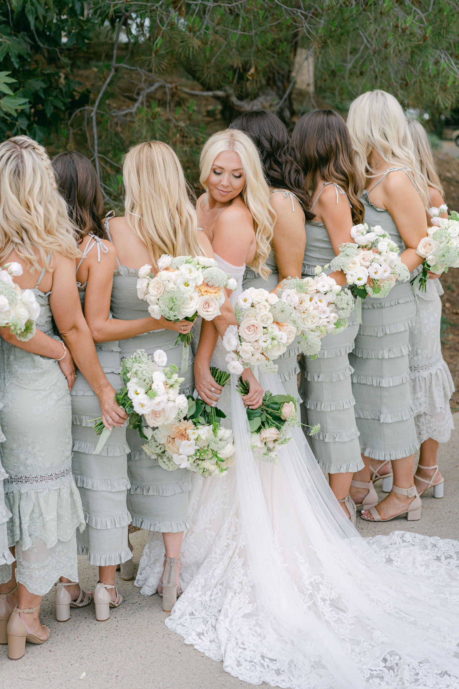 The bridal party in sage and black tie before the ceremony