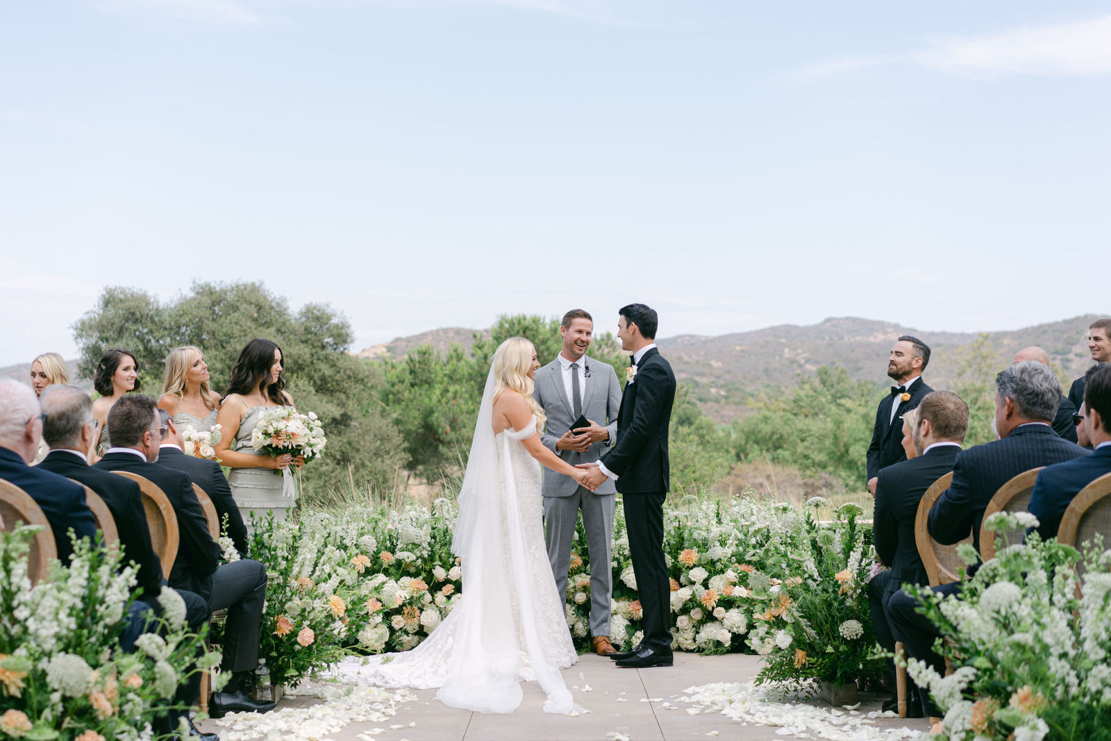 Vows on the terrace, the hills behind them